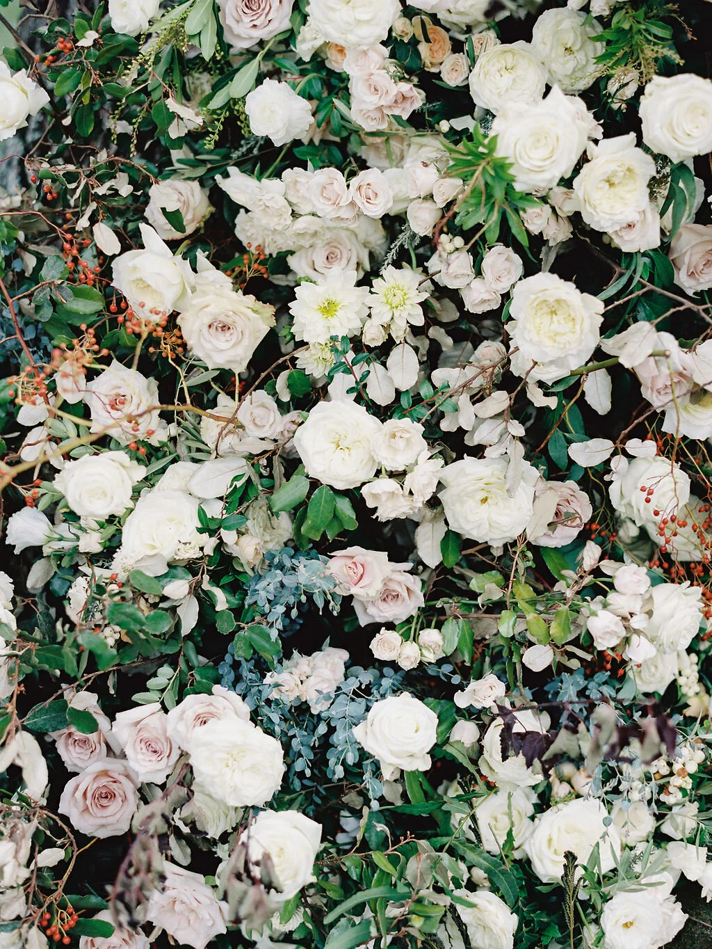 Lush floral installation on an old oak tree with natural vines and greenery with a profusion of white, ivory, and blush garden roses, dahlias, ranunculus, and wildflowers. Belle Meade, Nashville wedding floral design.