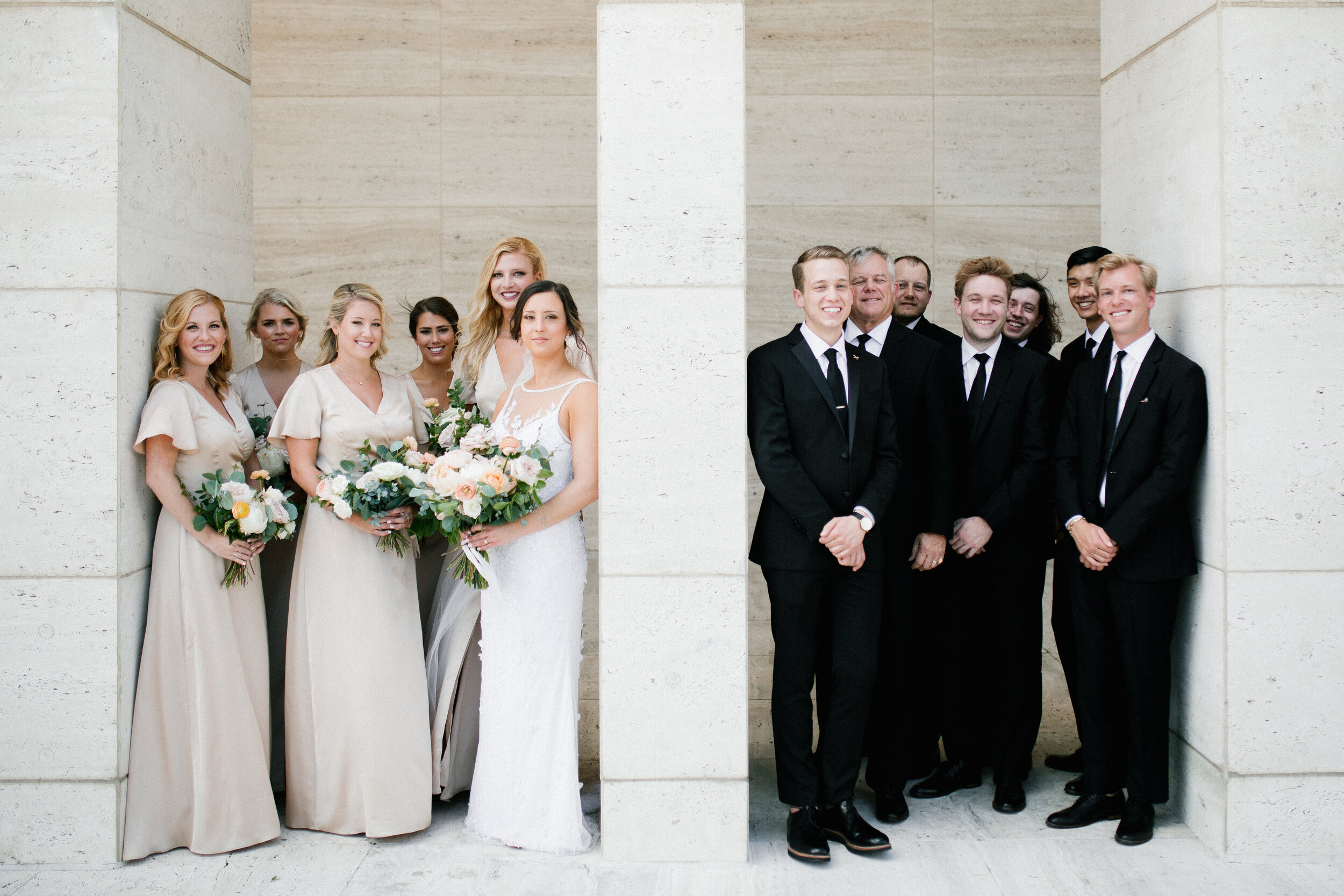 Bridal party portraits at Tennessee Tower in downtown Nashville. Asymmterical, whimsical bouquets with garden roses, ranunculus, and greenery.
