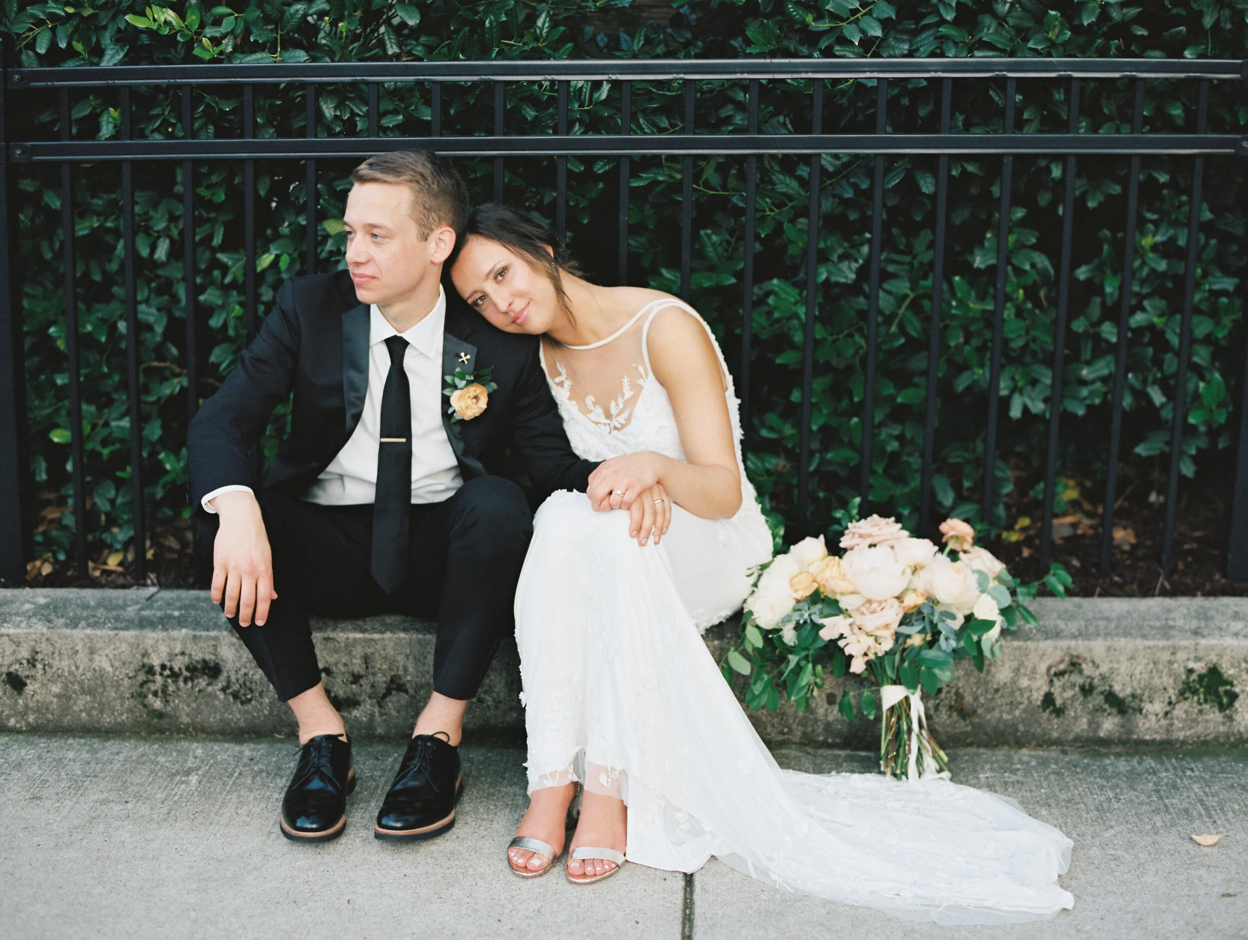 Bridal bouquet with peach ranunculus, cream peonies, blush and golden yellow garden roses, and natural, untamed greenery. June wedding at the Cordelle. Nashville Wedding Florist.