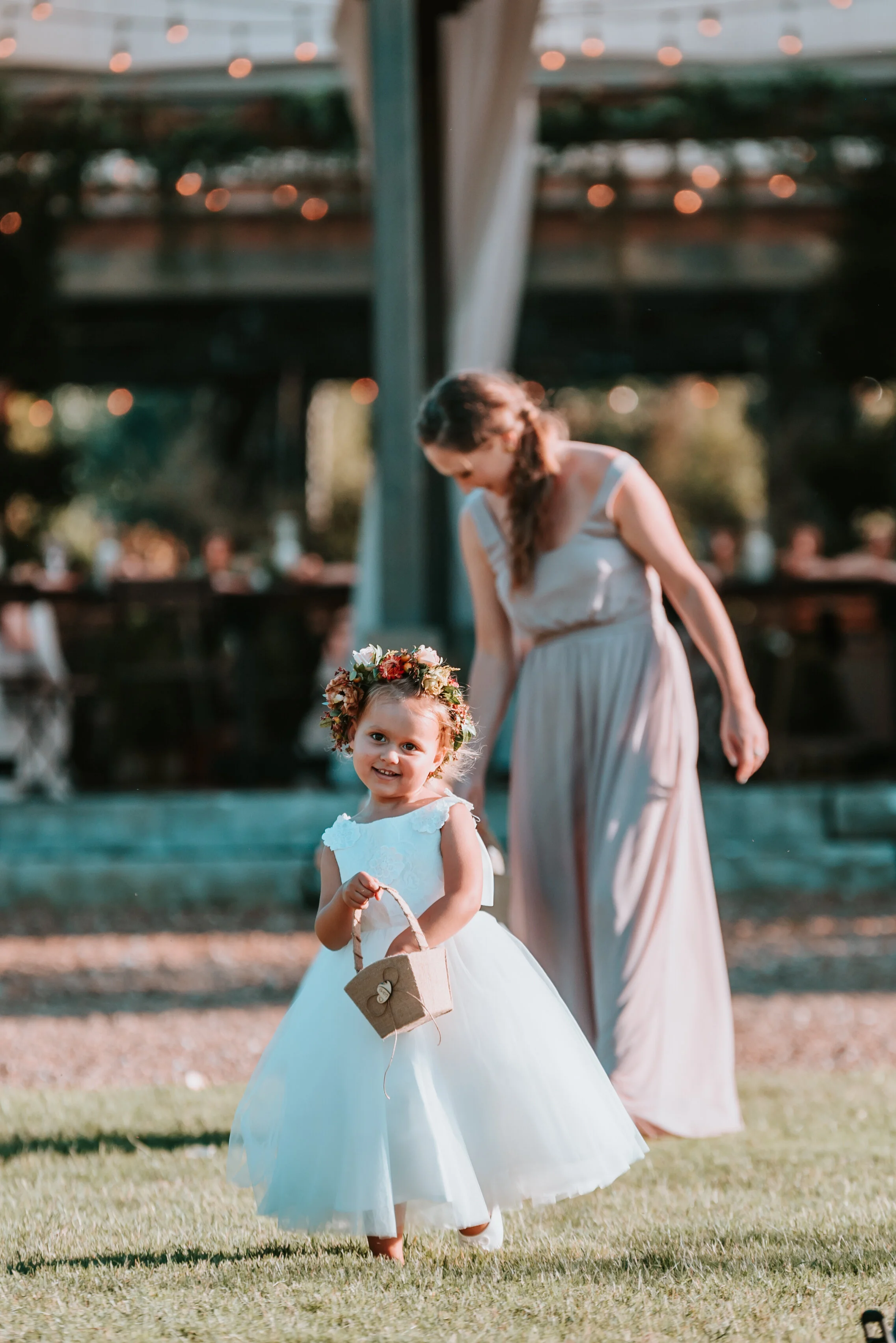 Dainty flower girl crown with burnt orange strawflower, peach spray roses, fall textures, and natural greenery. Nashville Wedding Florist.