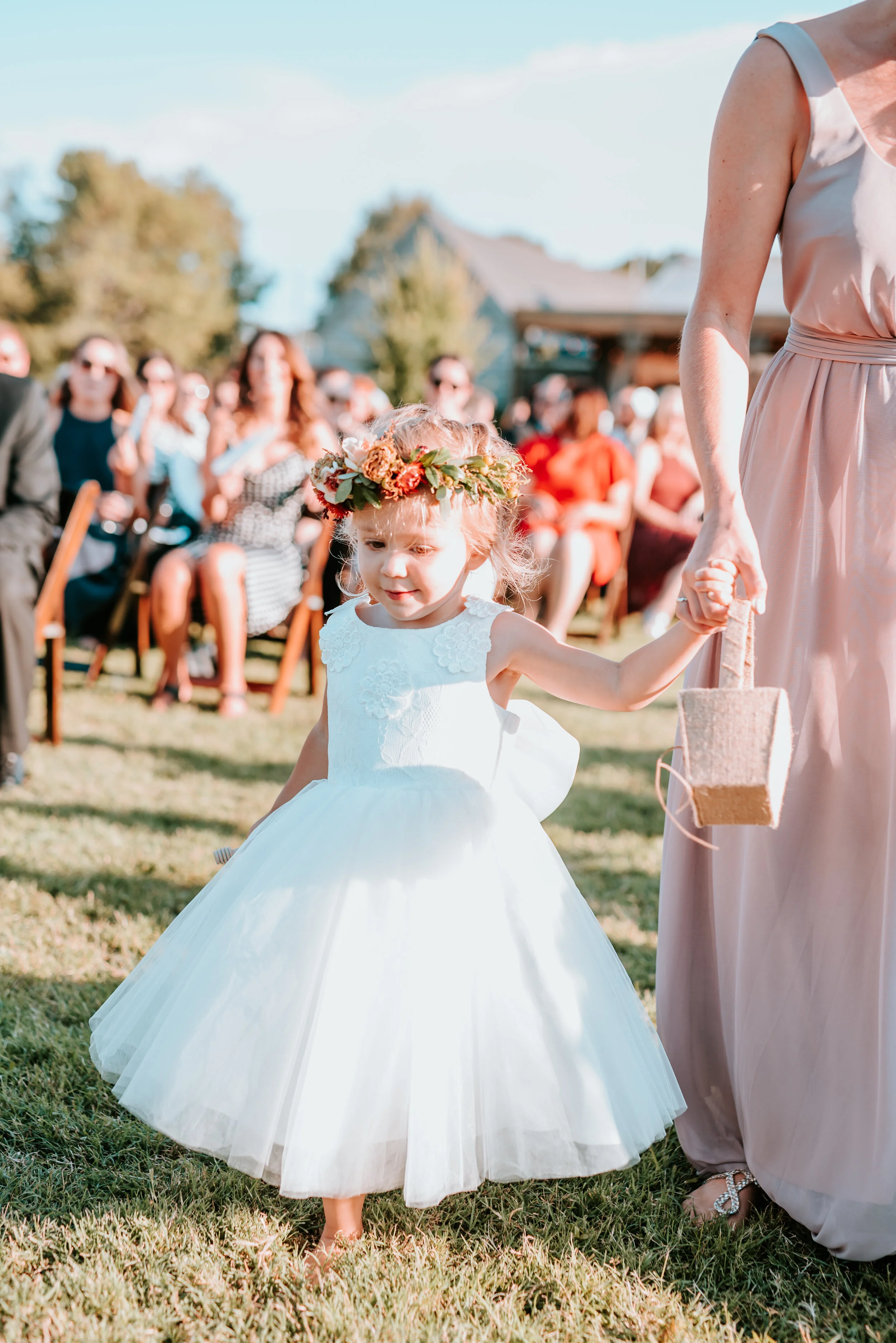 Dainty flower girl crown with burnt orange strawflower, peach spray roses, fall textures, and natural greenery. Nashville Wedding Florist.