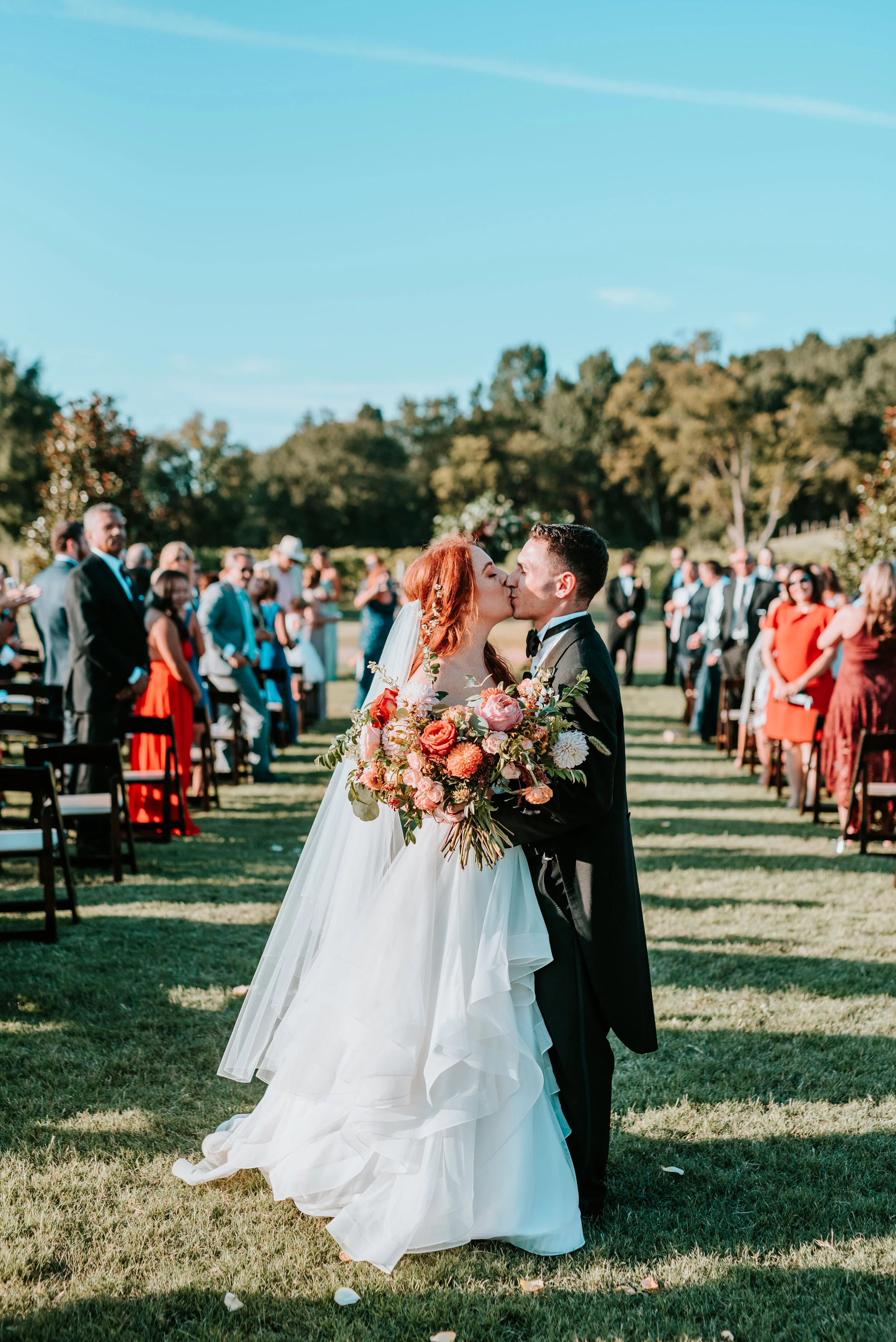 Fall bridal bouquet with garden roses, dahlias, and ranunculus in shades of burnt orange and peach, autumnal berries, and lush greenery. Nashville Wedding Floral Design.