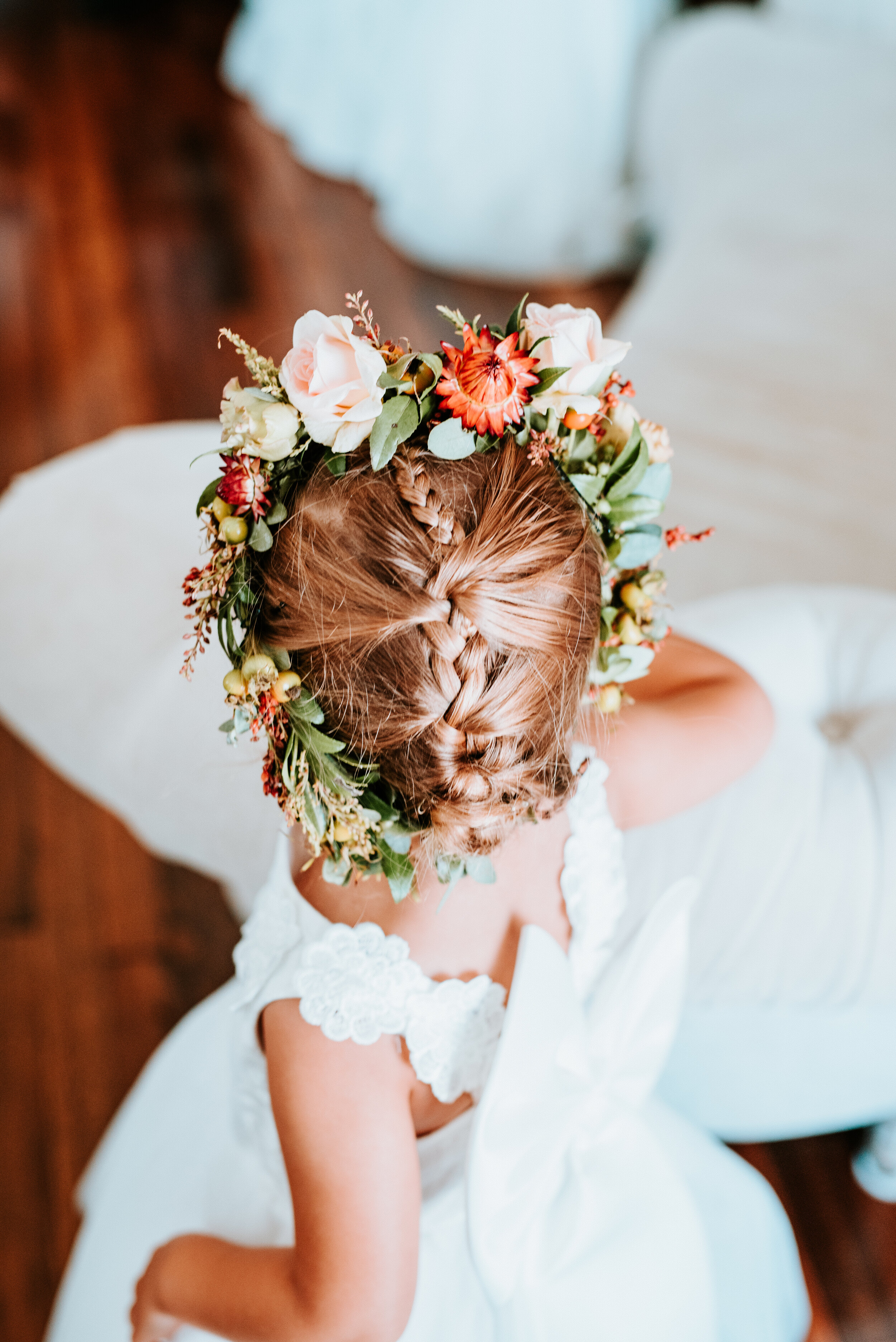 Dainty flower girl crown with burnt orange strawflower, peach spray roses, fall textures, and natural greenery. Nashville Wedding Florist.