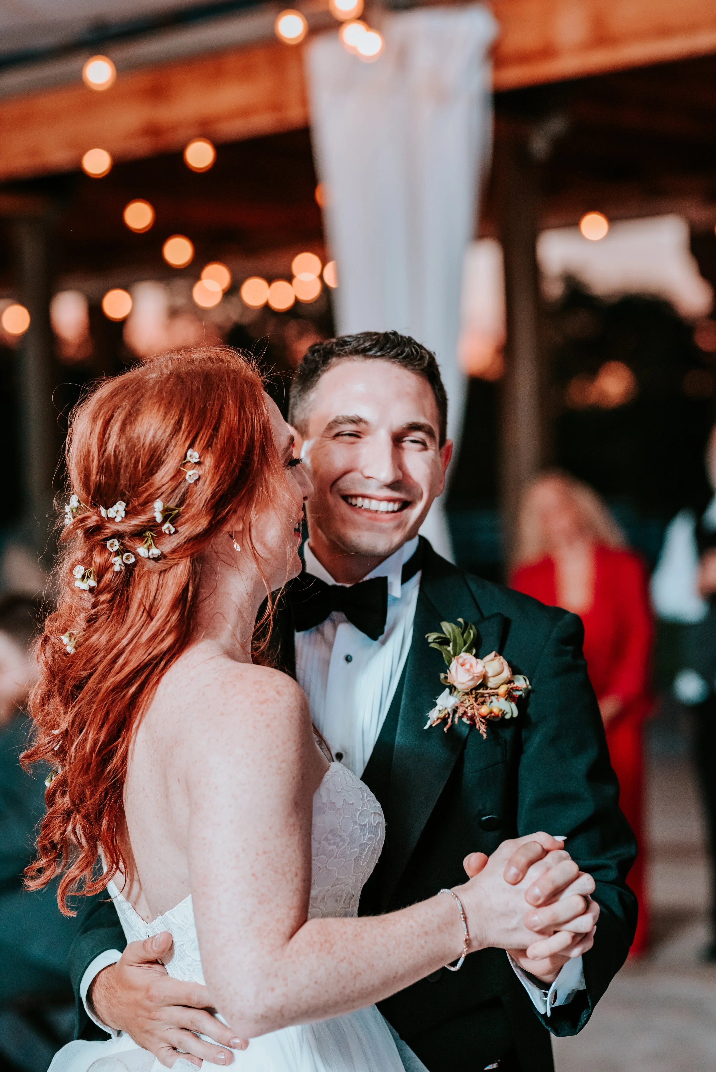 Soft peach spray rose boutonnieres with fall textures, berries, and greenery. Nashville wedding flowers.