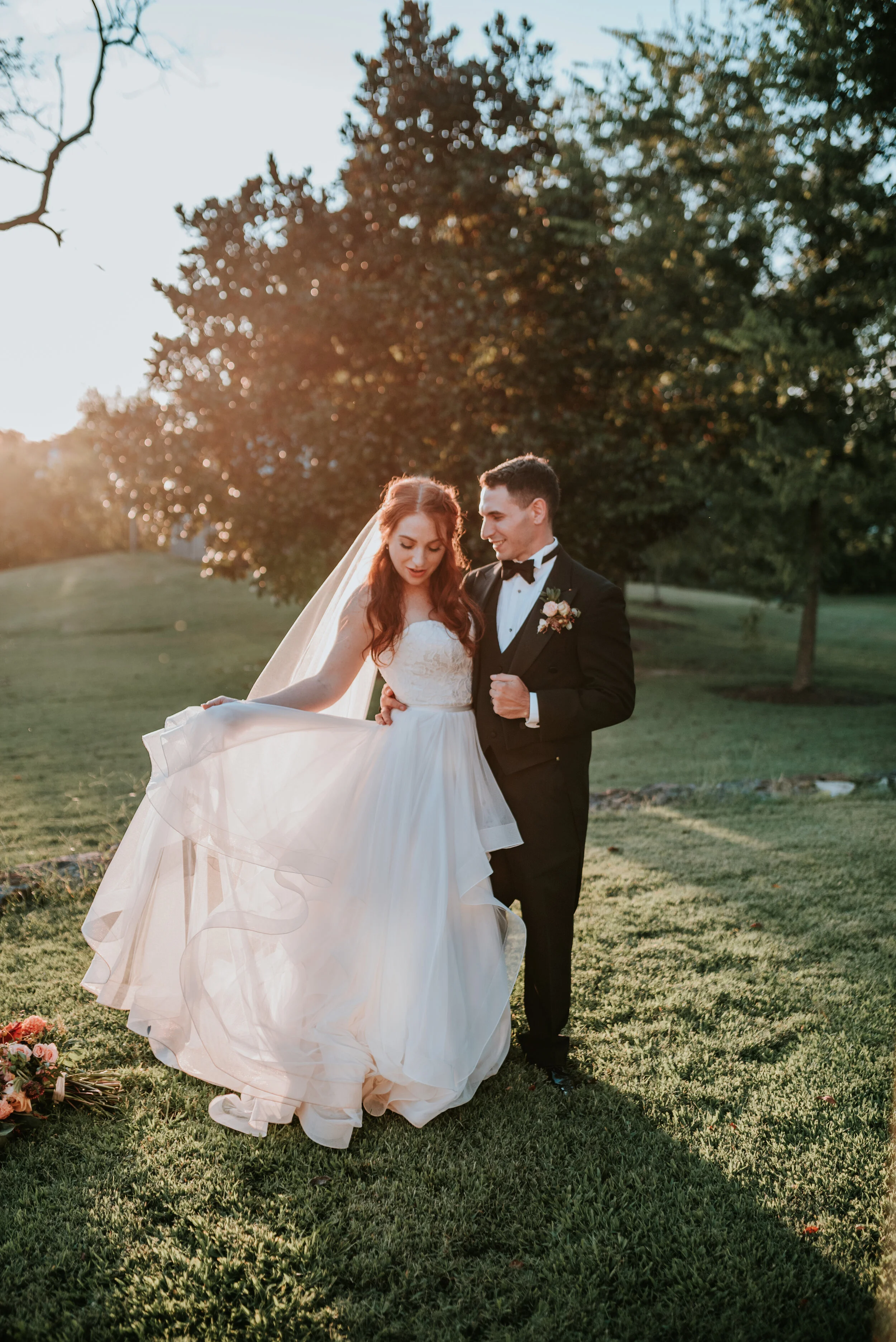 Fall bridal bouquet with garden roses, dahlias, and ranunculus in shades of burnt orange and peach, autumnal berries, and lush greenery. Nashville Wedding Floral Design.