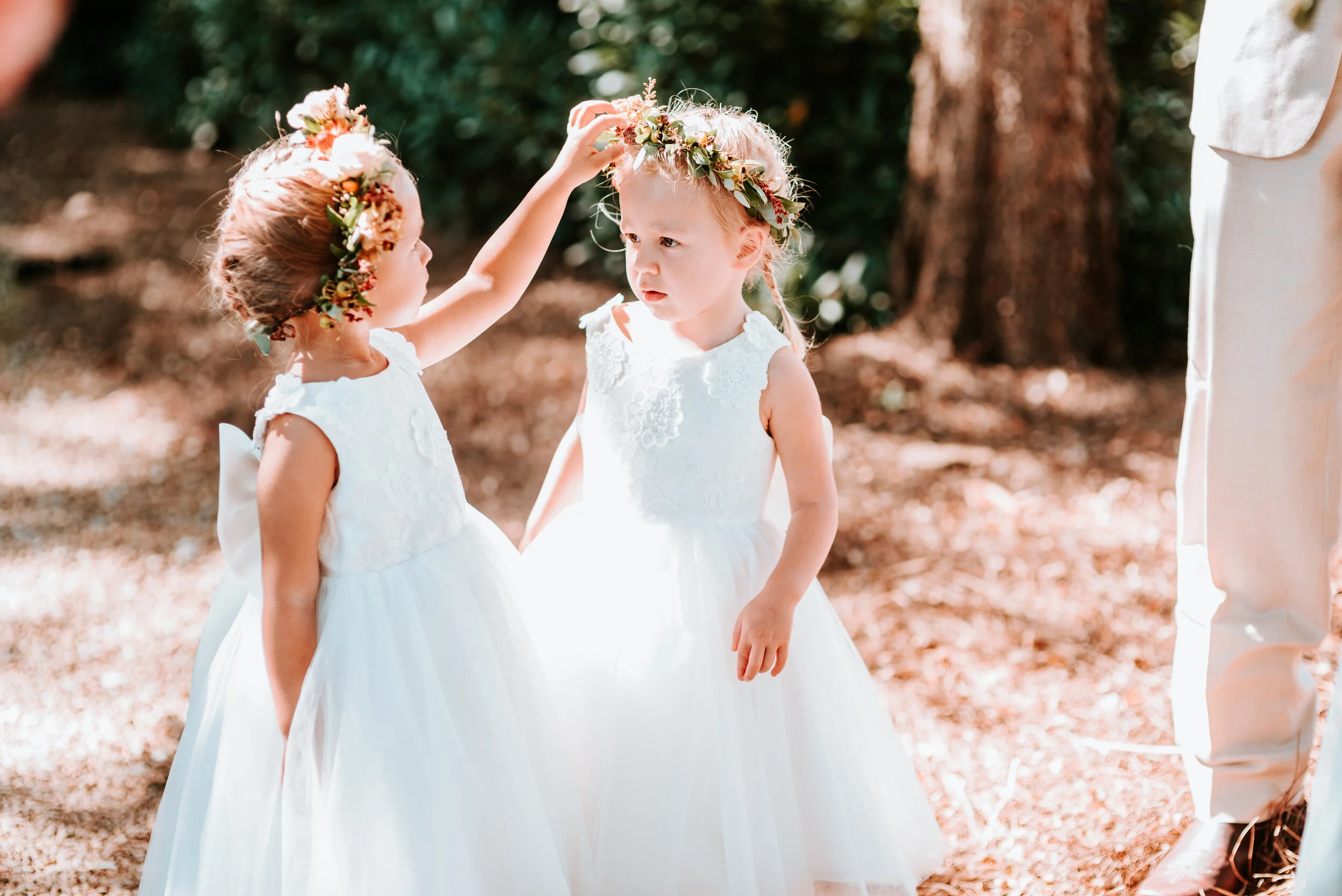Dainty flower girl crown with burnt orange strawflower, peach spray roses, fall textures, and natural greenery. Nashville Wedding Florist.