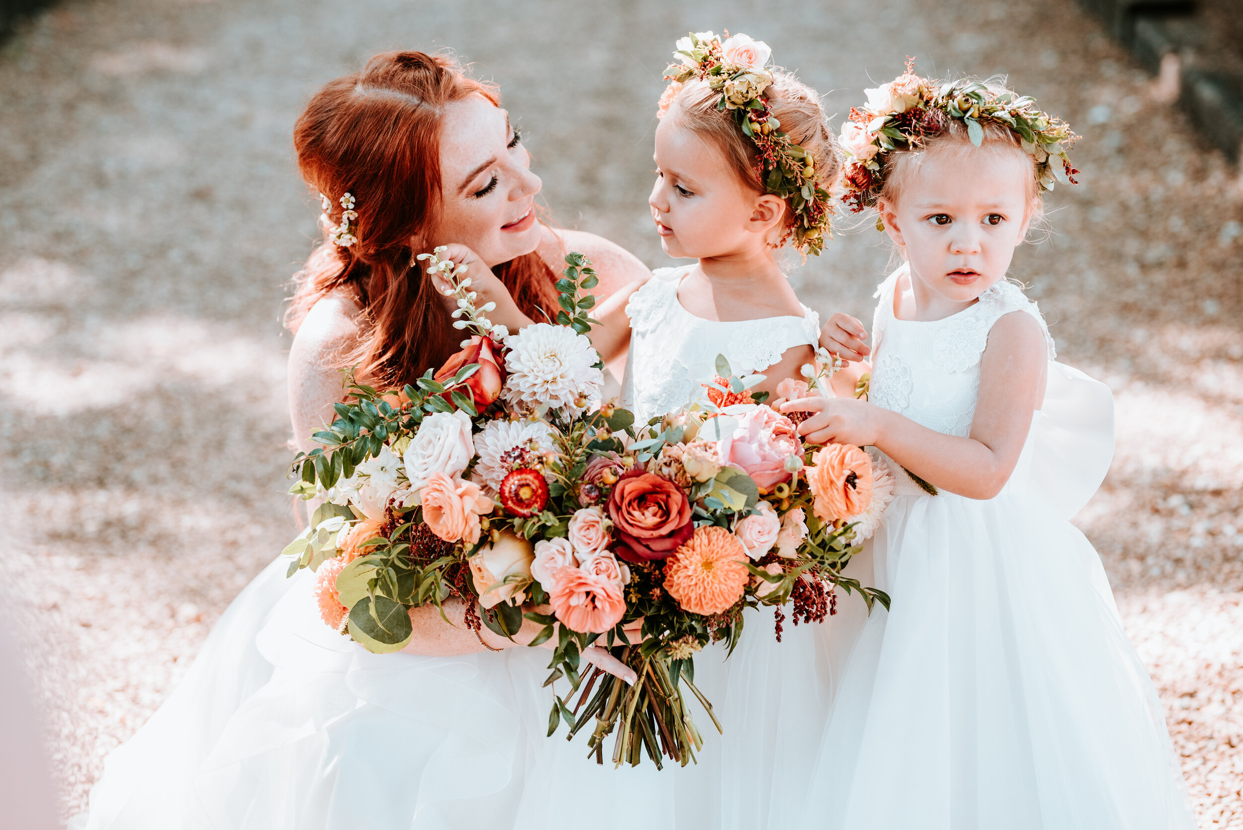 Dainty flower girl crown with burnt orange strawflower, peach spray roses, fall textures, and natural greenery. Nashville Wedding Florist.