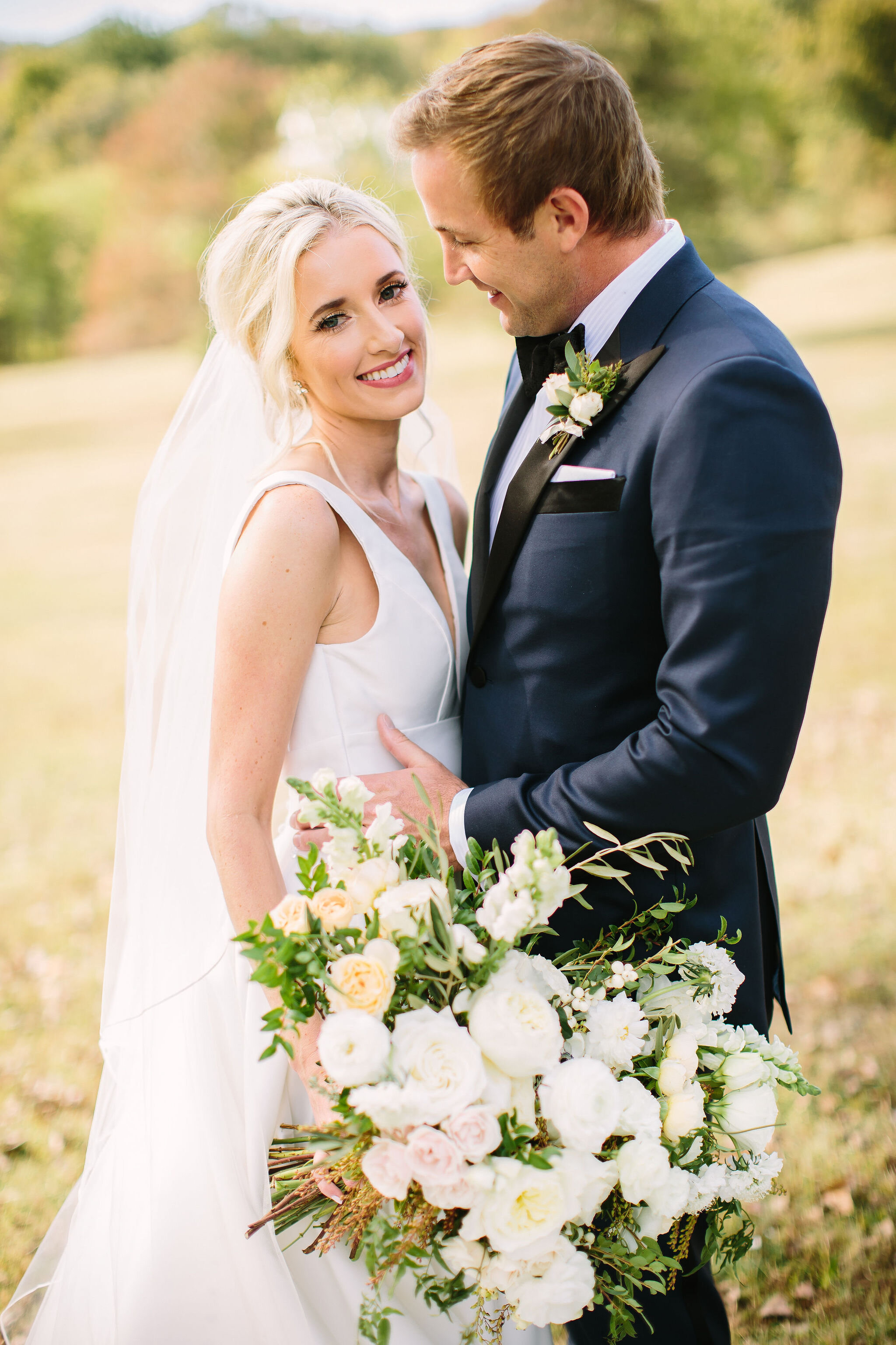 Tennessee countryside October wedding at Bloomsberry Farm with all white and greenery floral design. Nashville wedding florist.