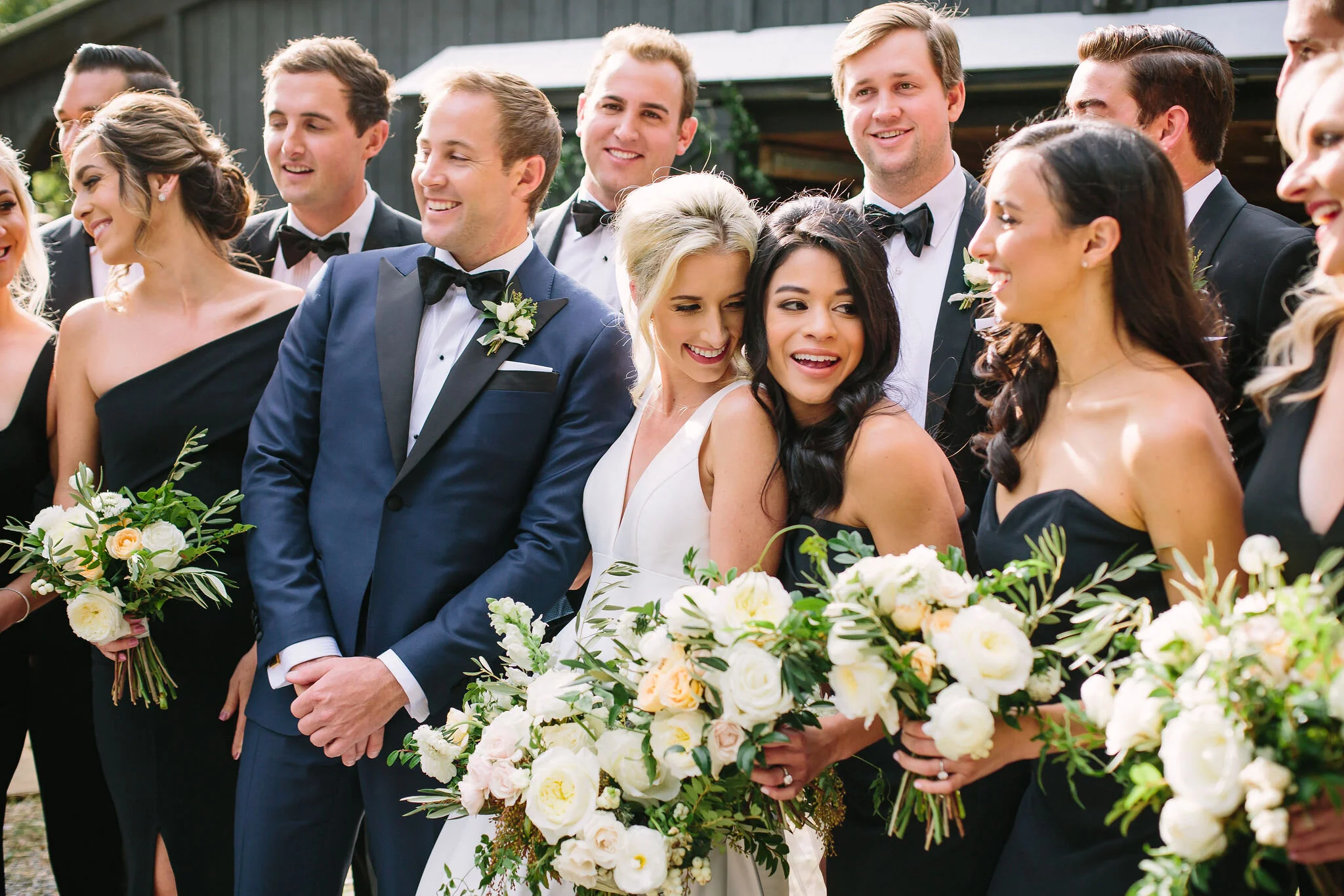 Black bridesmaid dresses with all white and greenery bouquets. Nashville wedding florist at Bloomsberry Farm.