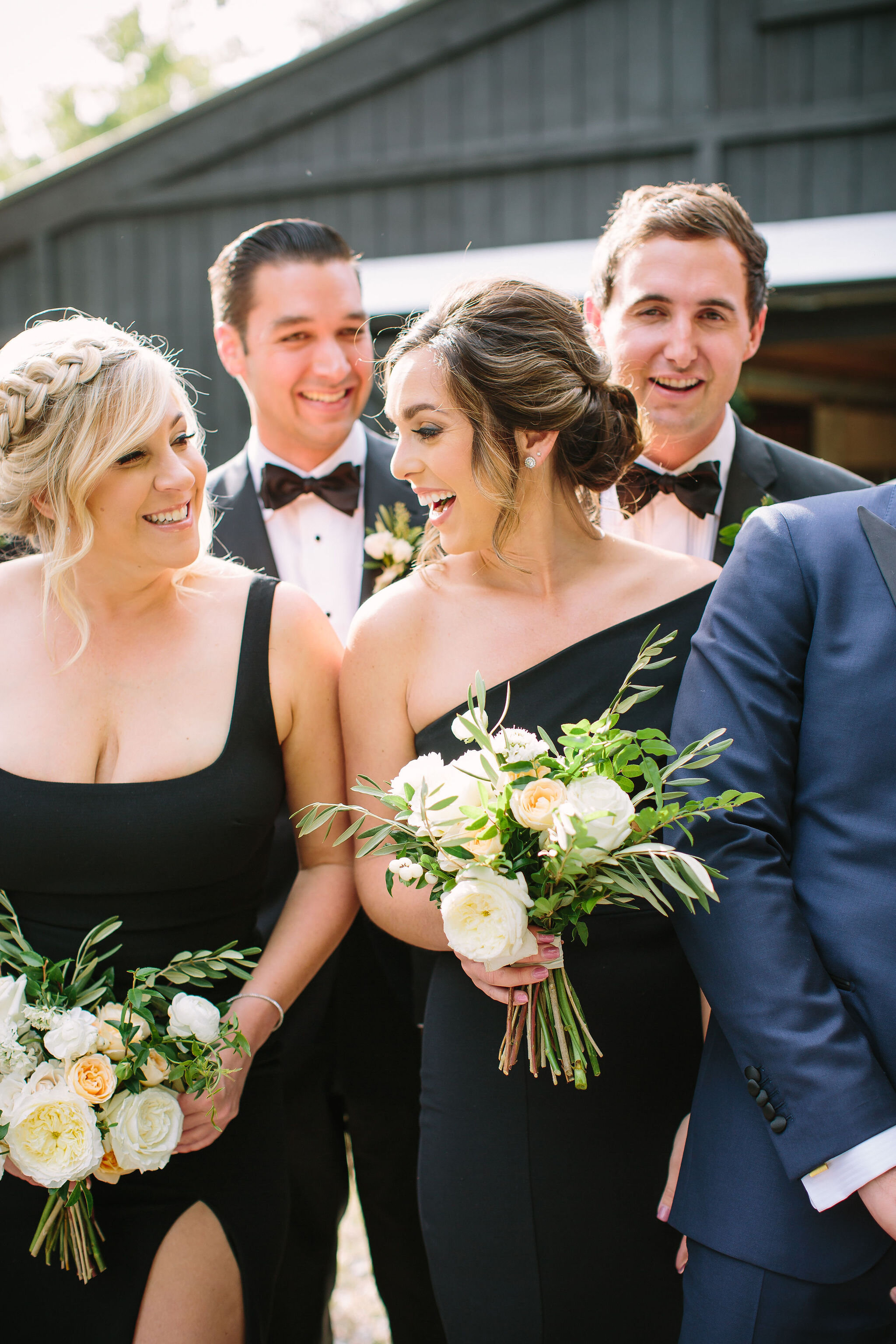 Black bridesmaid dresses with all white and greenery bouquets. Nashville wedding florist at Bloomsberry Farm.