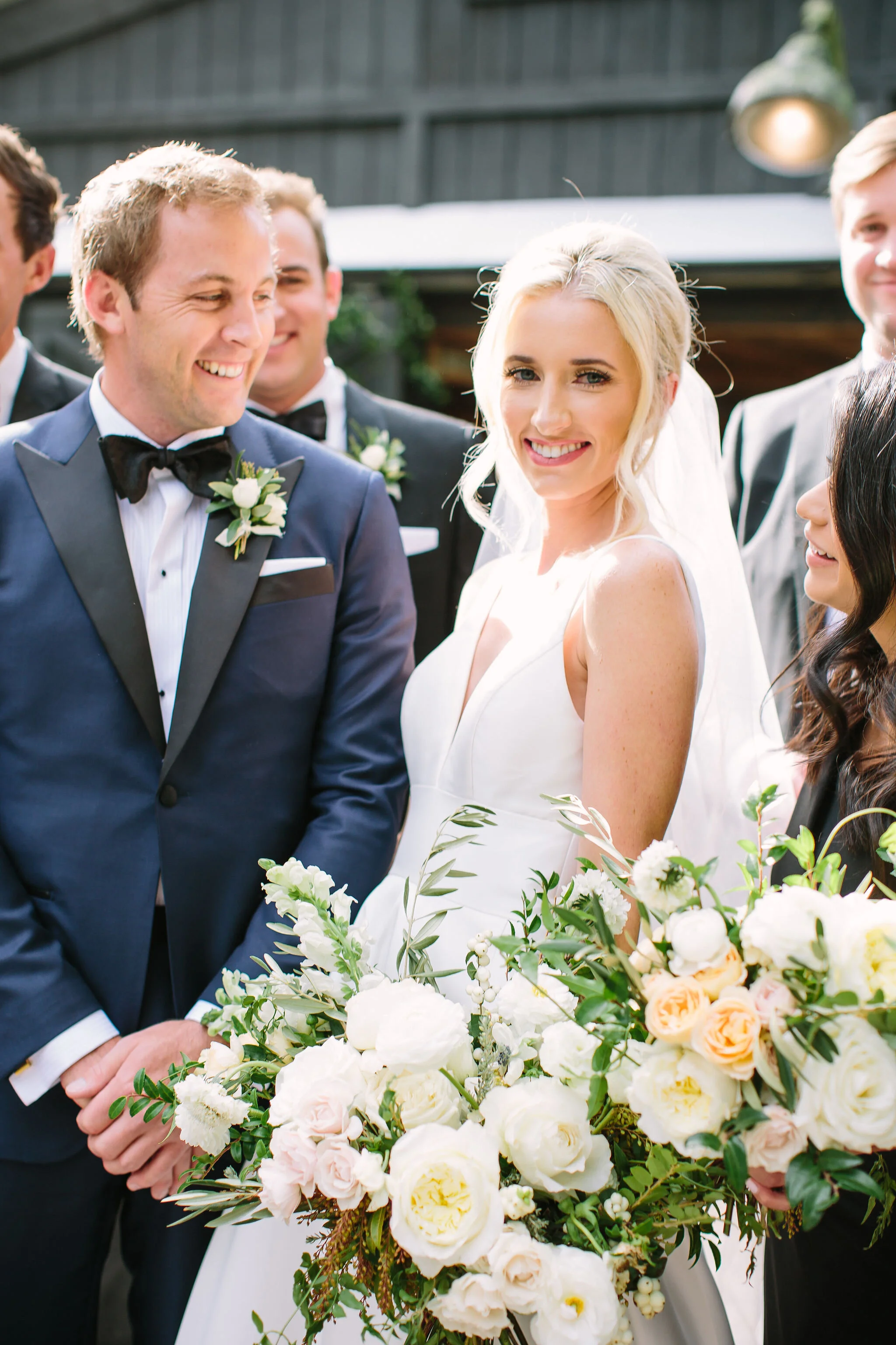 Black bridesmaid dresses with all white and greenery bouquets. Nashville wedding florist at Bloomsberry Farm.