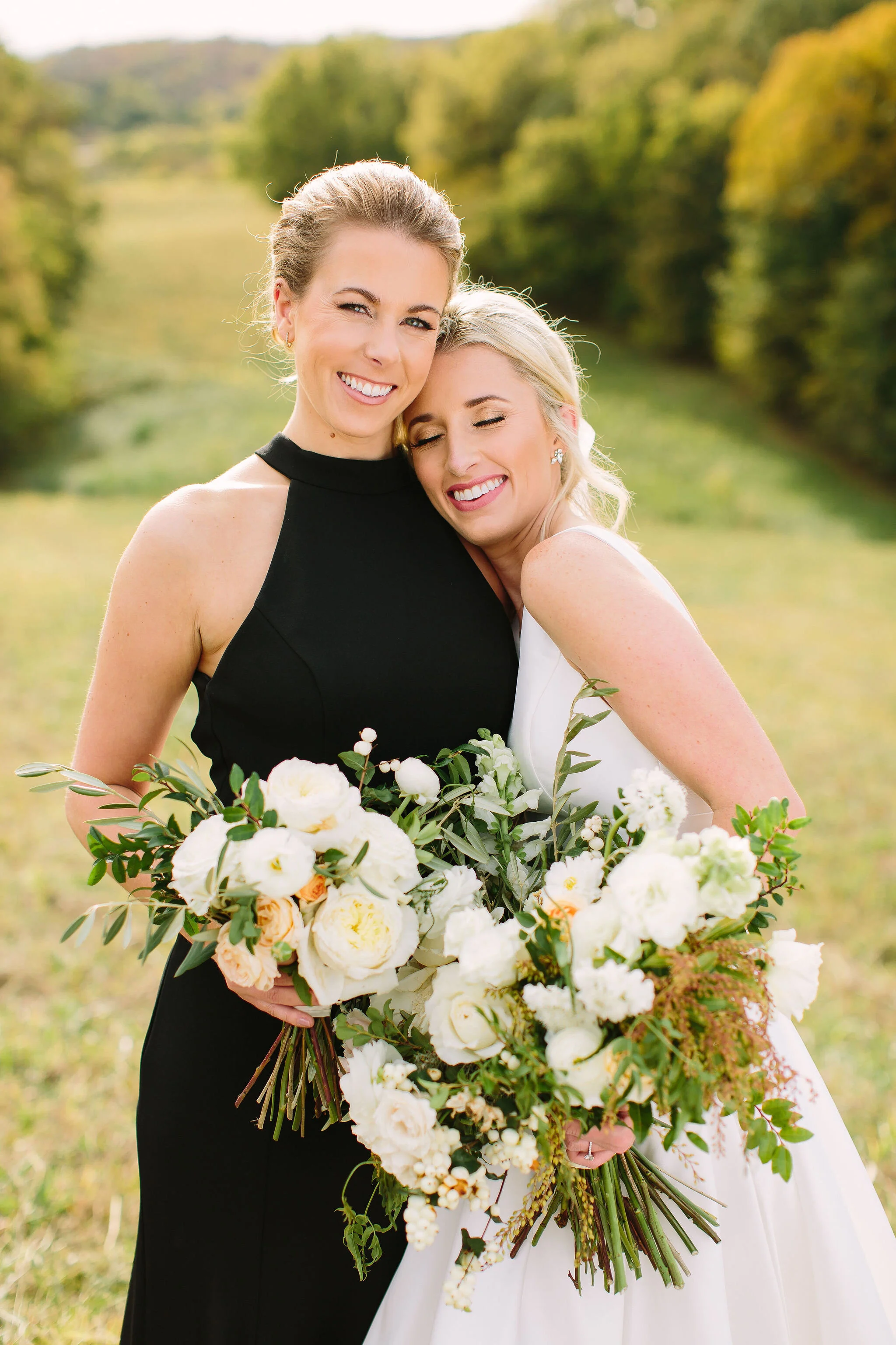 Black bridesmaid dresses with all white and greenery bouquets. Nashville wedding florist at Bloomsberry Farm.