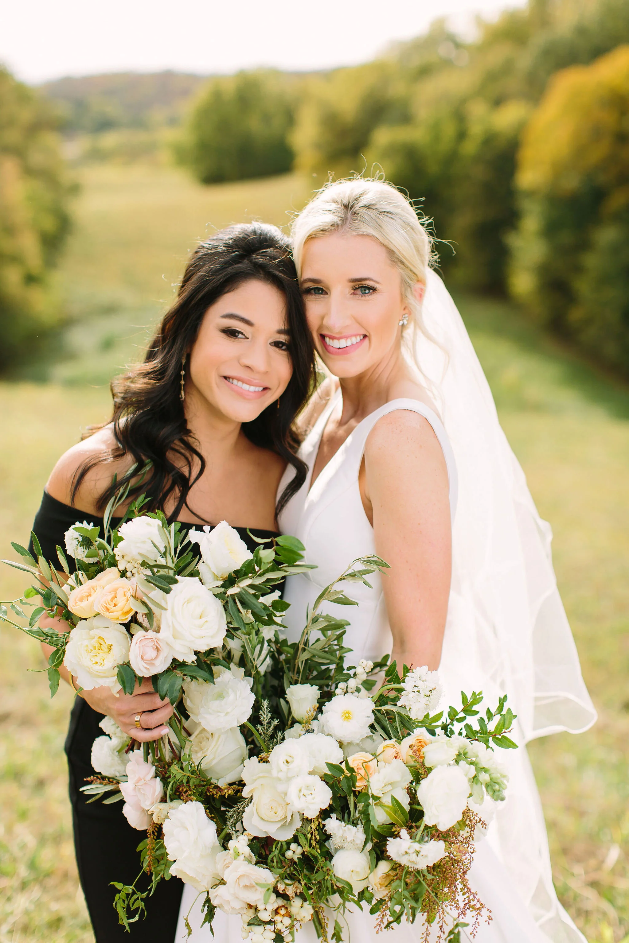 Black bridesmaid dresses with all white and greenery bouquets. Nashville wedding florist at Bloomsbury Farm.