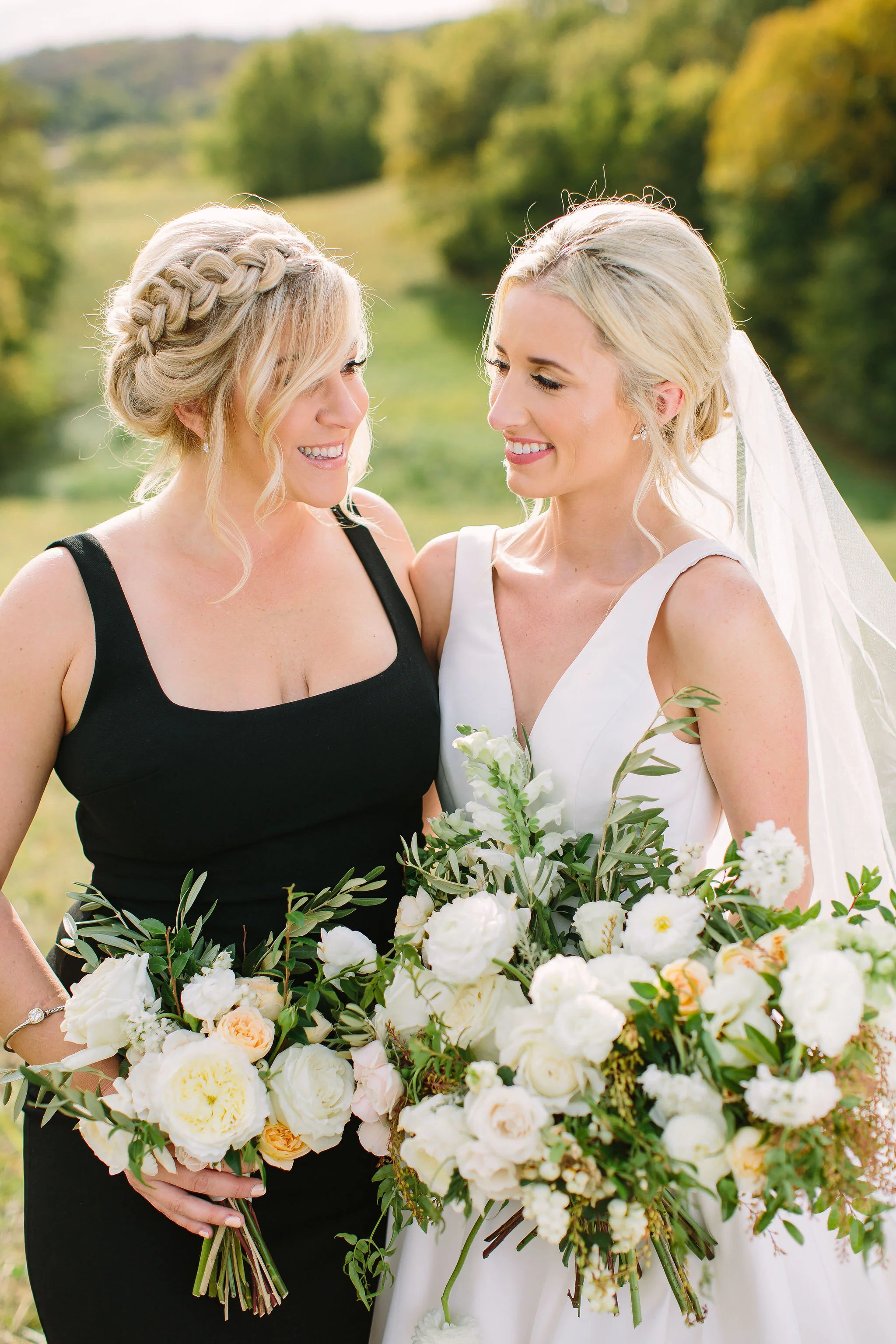 Black bridesmaid dresses with all white and greenery bouquets. Nashville wedding florist at Bloomsbury Farm.