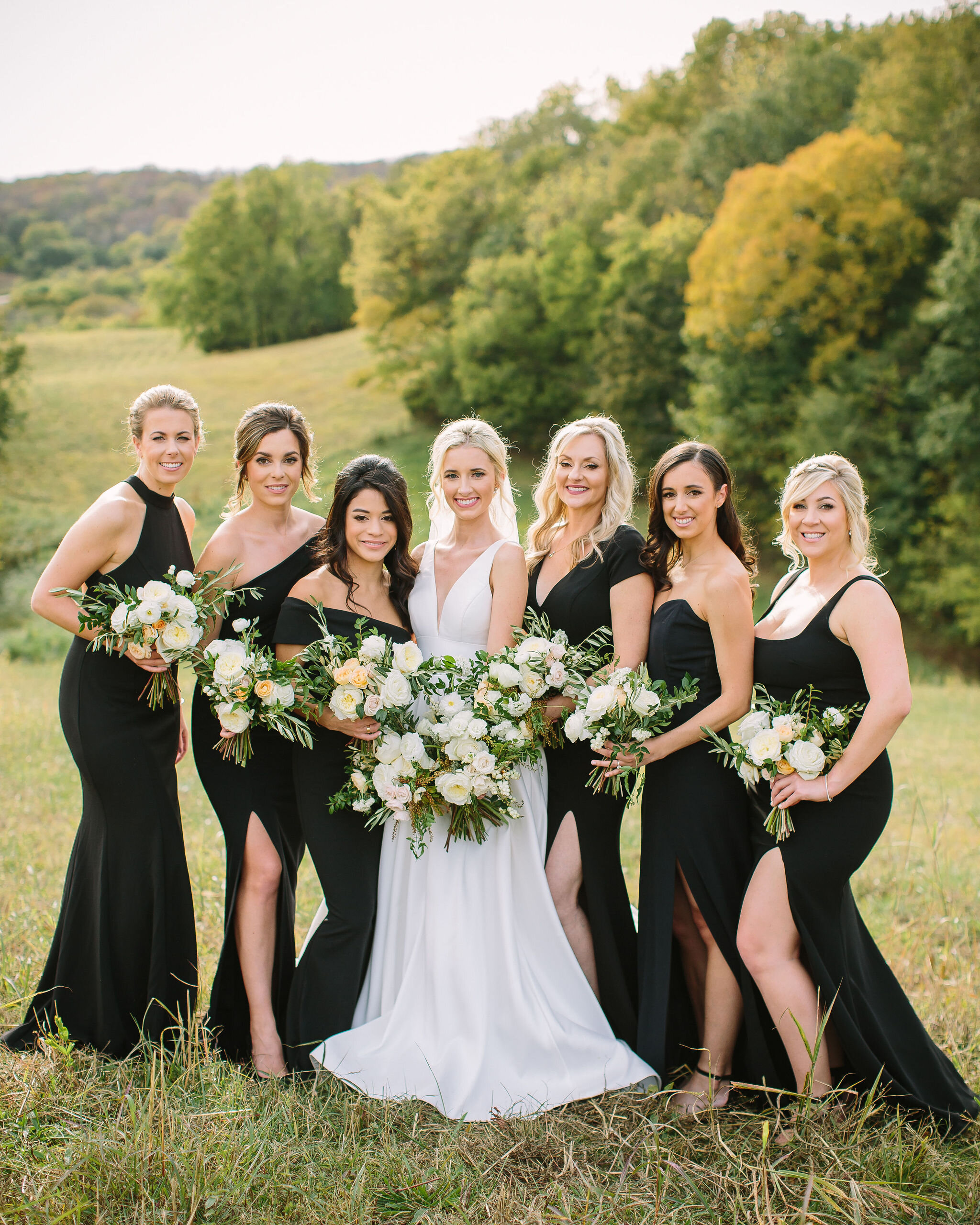 Black bridesmaid dresses with all white and greenery bouquets. Nashville wedding florist at Bloomsbury Farm.