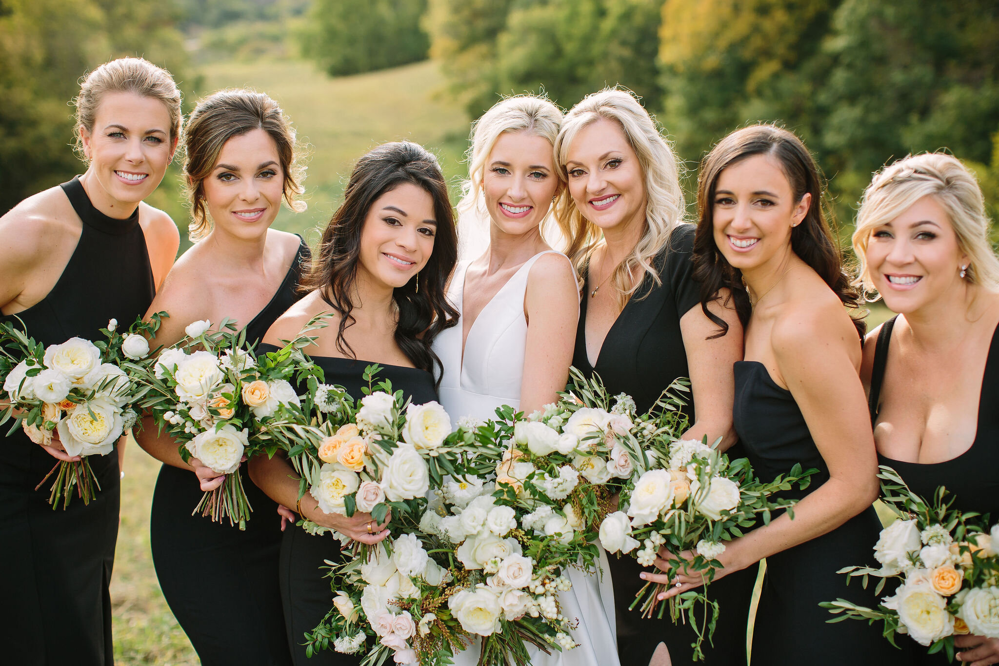 Black bridesmaid dresses with all white and greenery bouquets. Nashville wedding florist at Bloomsbury Farm.