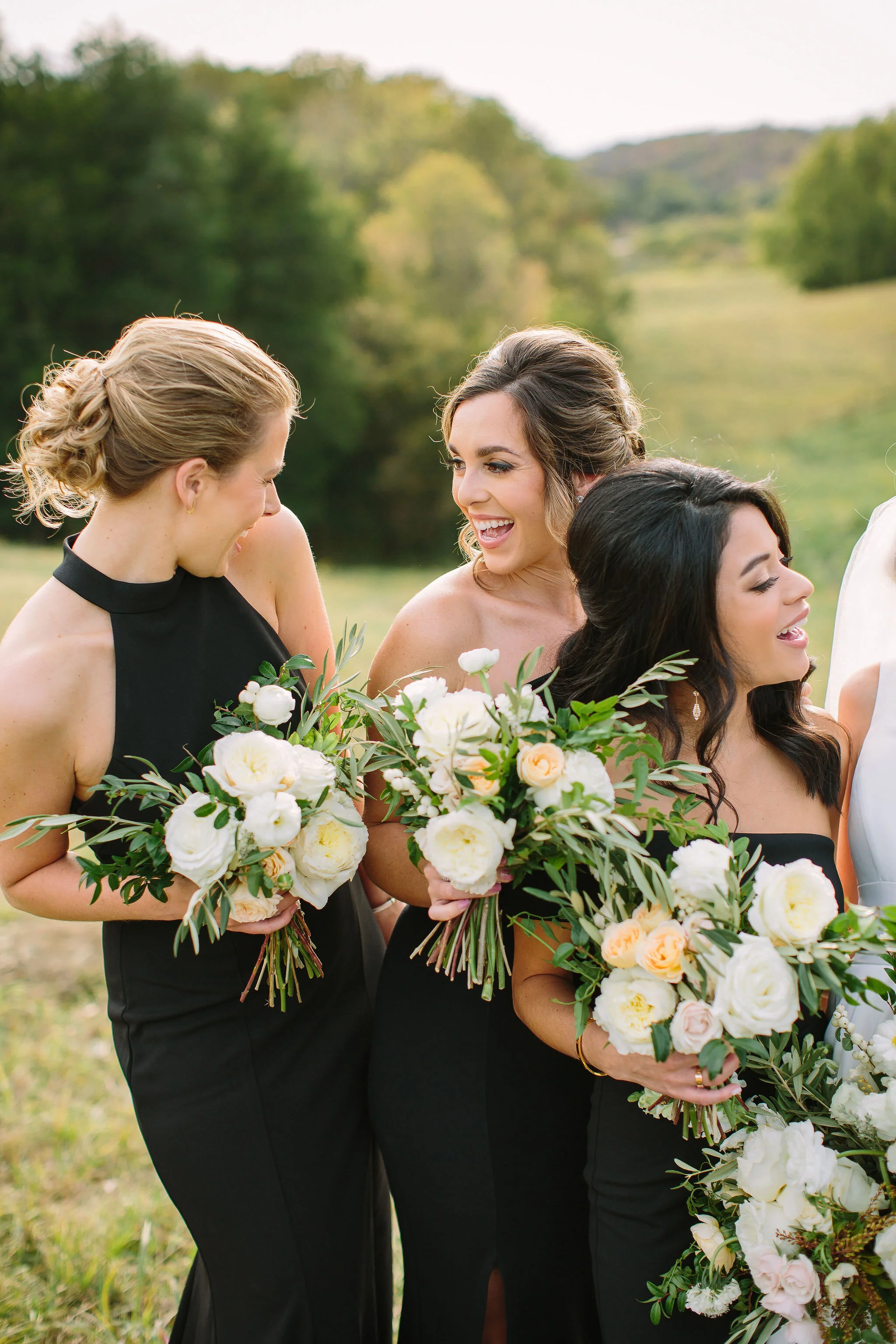 Black bridesmaid dresses with all white and greenery bouquets. Nashville wedding florist at Bloomsbury Farm.