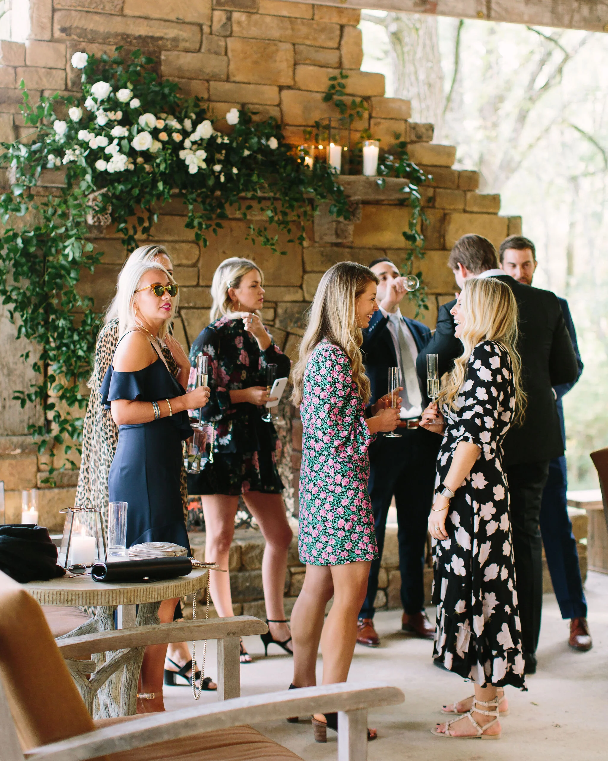 Asymmetrical floral installation for the mantle with trailing vines and white flowers. Wedding floral design at Bloomsbury Farms.