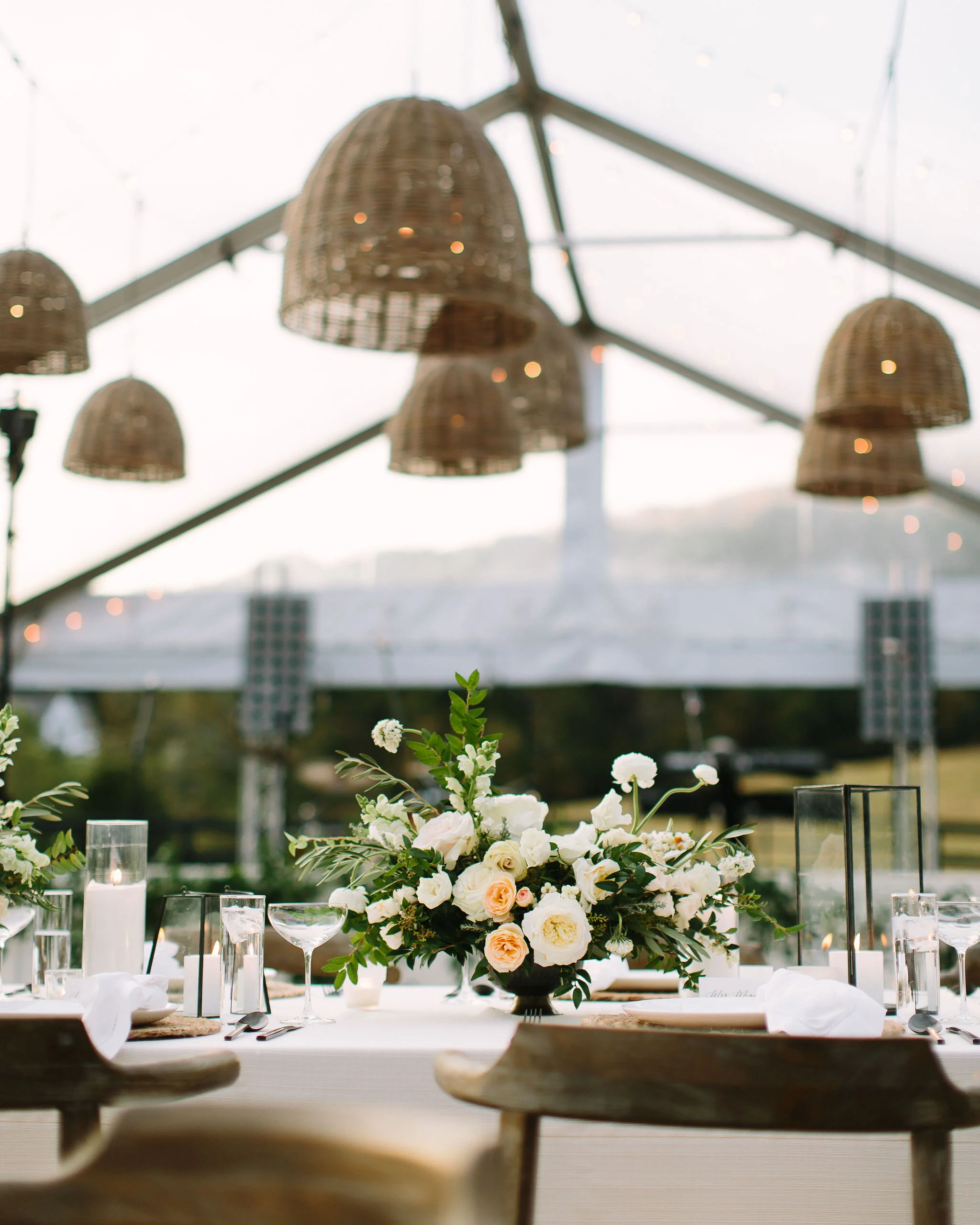 Whimsical floral centerpiece in a gold compote vase with white ranunculus, garden roses, and greenery. Nashville wedding florist at Bloomsbury Farm.