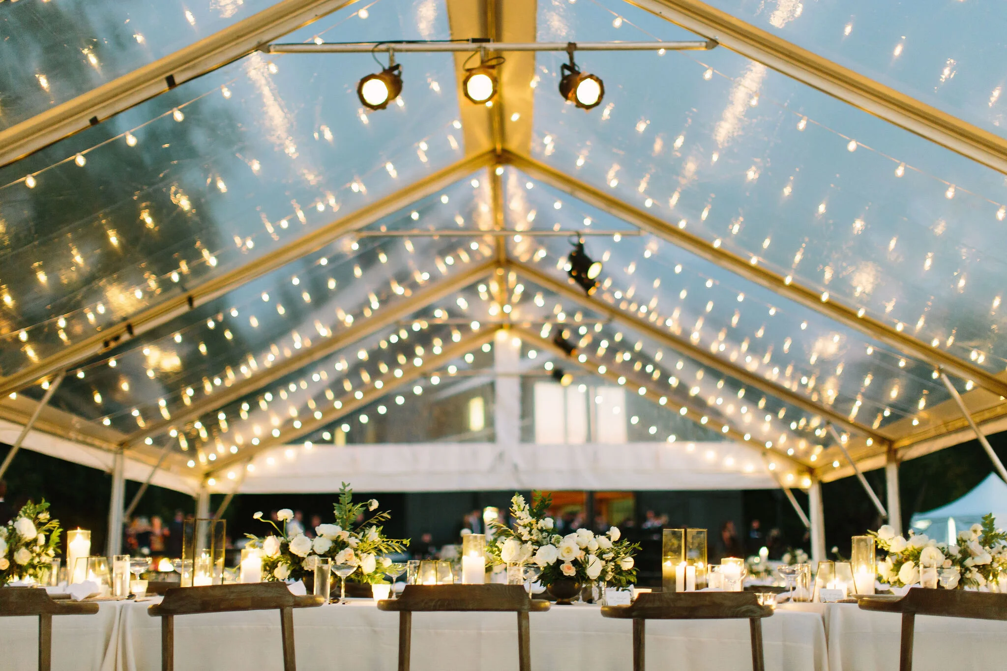 Whimsical floral centerpiece in a gold compote vase with white ranunculus, garden roses, and greenery. Nashville wedding florist at Bloomsbury Farm.
