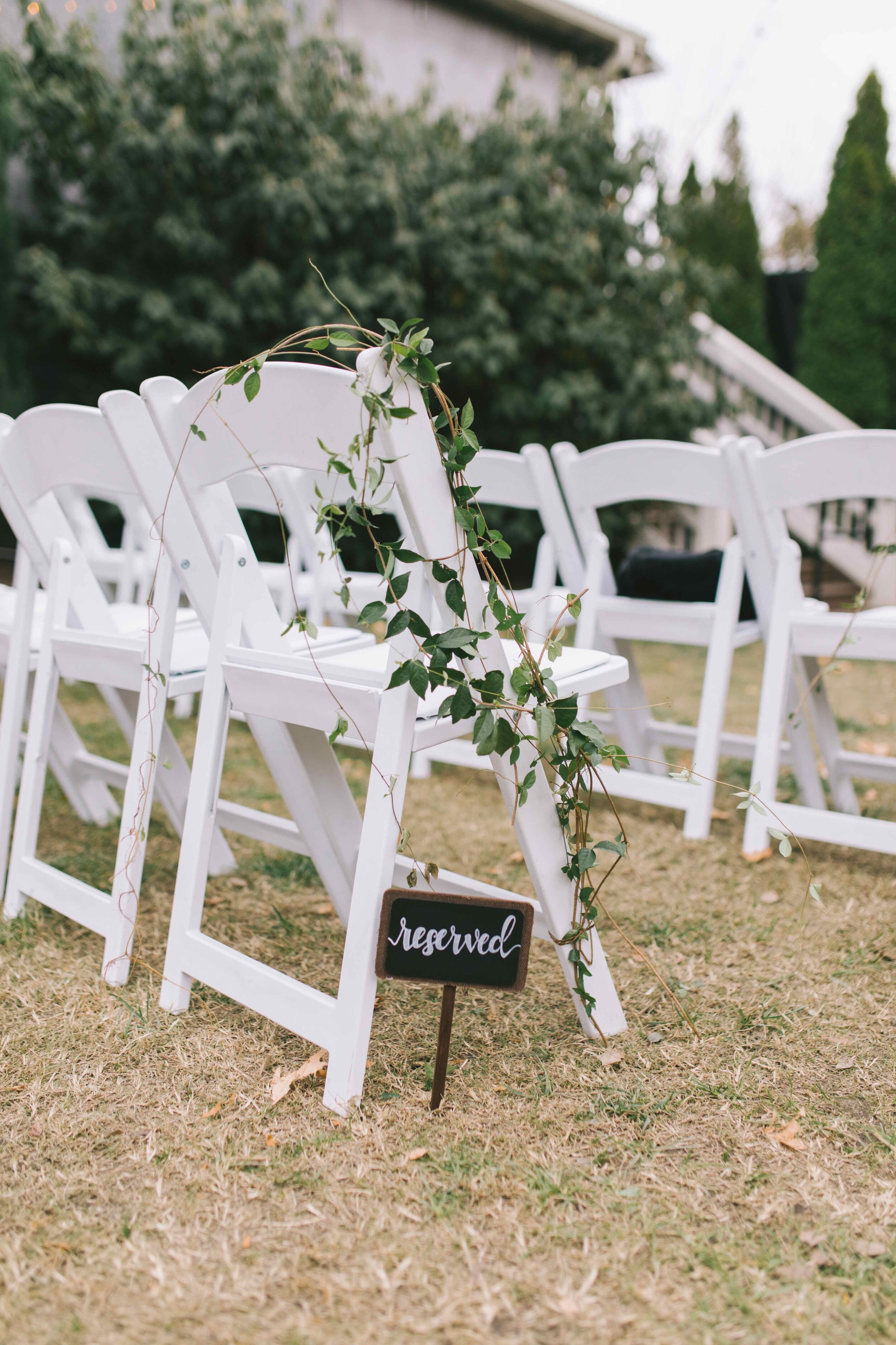 Untamed vine-like greenery aisle markers. Nashville wedding floral design at the Cordelle.