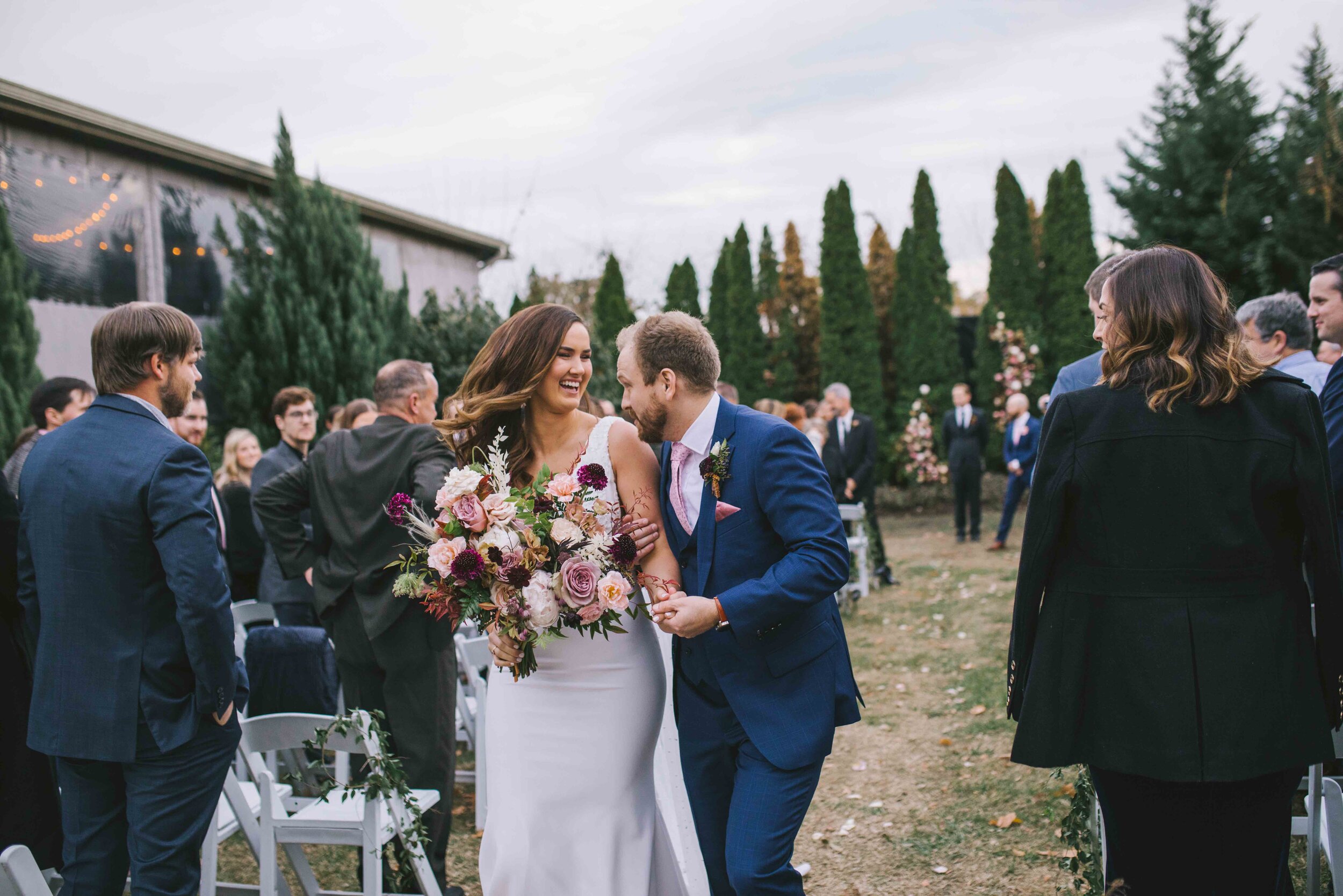 Organic floral installation in the cedar trees as the wedding ceremony backdrop. Nashville florist at the Cordelle.