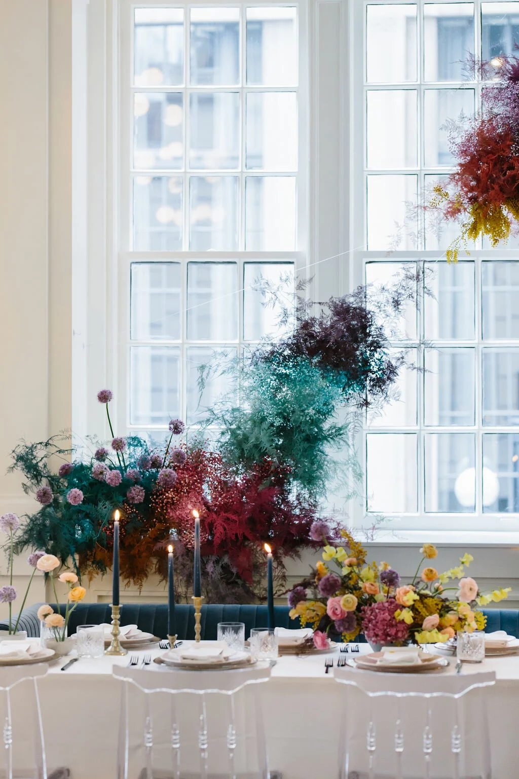 Rainbow colored floral installation with painted and dyed baby’s breath and plums ferns. Modern, minimal, colorful wedding flowers at the Noelle Hotel in downtown Nashville.