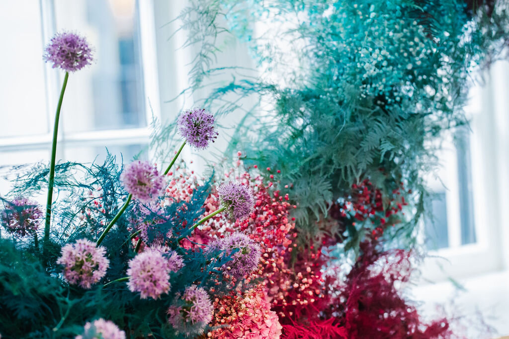 Rainbow colored floral installation with painted and dyed baby’s breath and plums ferns. Modern, minimal, colorful wedding flowers at the Noelle Hotel in downtown Nashville.