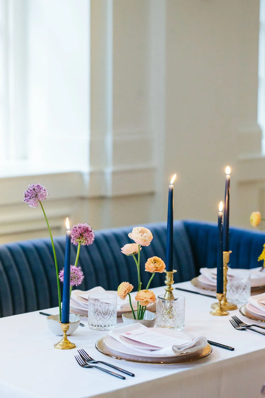 Minimal, modern ikebana centerpieces with purple allium and peach ranunculus. Nashville wedding floral design at the Noelle Hotel.