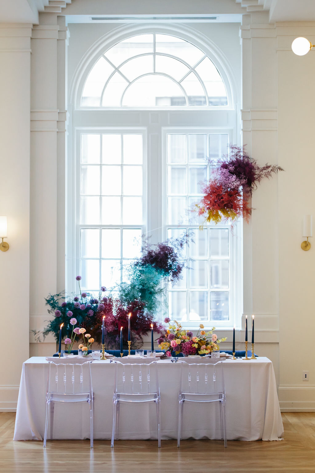 Rainbow colored floral installation with painted and dyed baby’s breath and plums ferns. Modern, minimal, colorful wedding flowers at the Noelle Hotel in downtown Nashville.