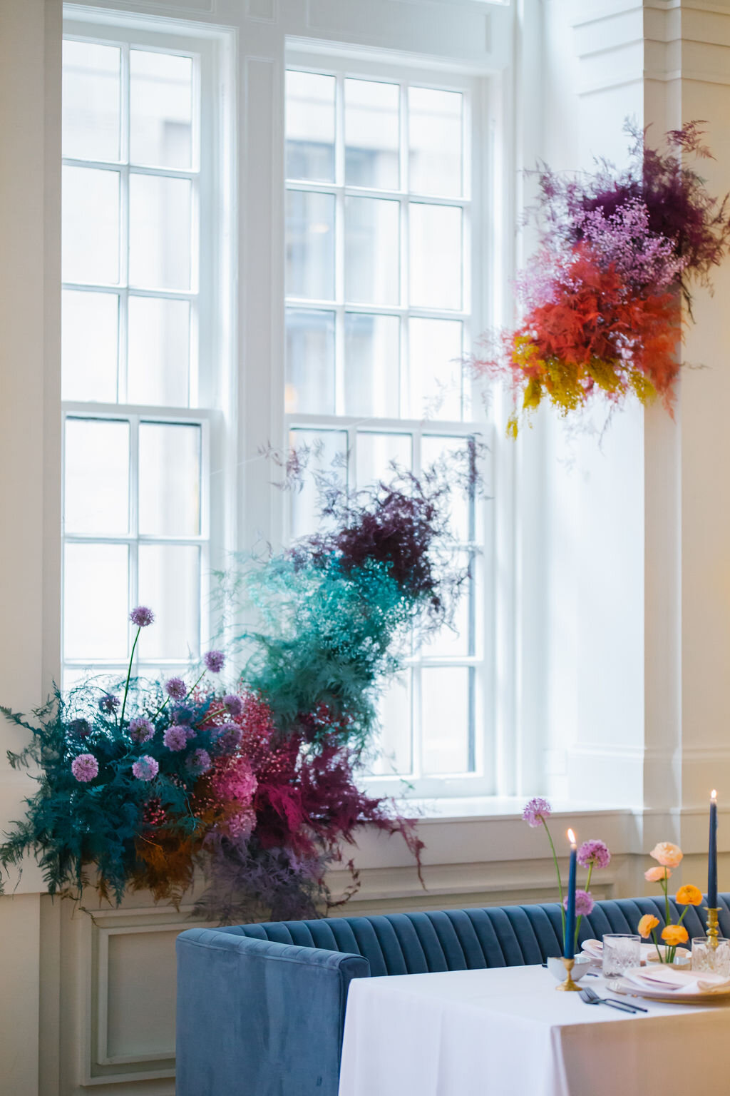 Rainbow colored floral installation with painted and dyed baby’s breath and plums ferns. Modern, minimal, colorful wedding flowers at the Noelle Hotel in downtown Nashville.