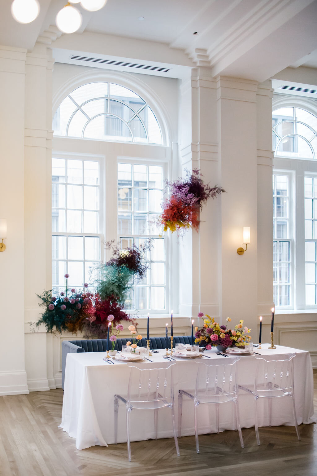 Rainbow colored floral installation with painted and dyed baby’s breath and plums ferns. Modern, minimal, colorful wedding flowers at the Noelle Hotel in downtown Nashville.