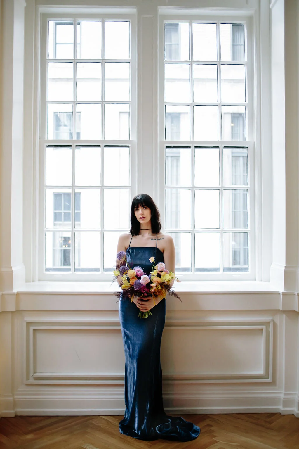 Modern, colorful bridal bouquet with yellow sweet peas, purple allium, pink and peach ranunculus, golden acacia, and painted eggplant plums fern. Nashville wedding florist.