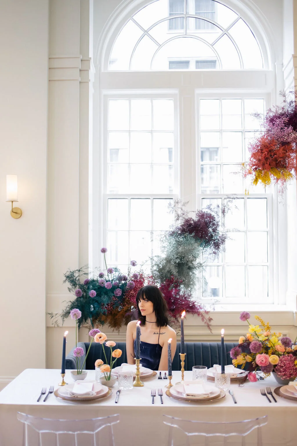 Rainbow colored floral installation with painted and dyed baby’s breath and plums ferns. Modern, minimal, colorful wedding flowers at the Noelle Hotel in downtown Nashville.