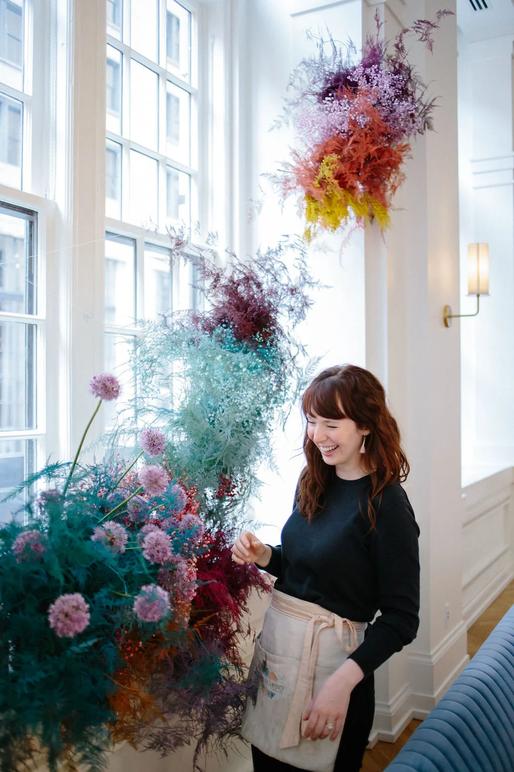 Rainbow colored floral installation with painted and dyed baby’s breath and plums ferns. Modern, minimal, colorful wedding flowers at the Noelle Hotel in downtown Nashville.