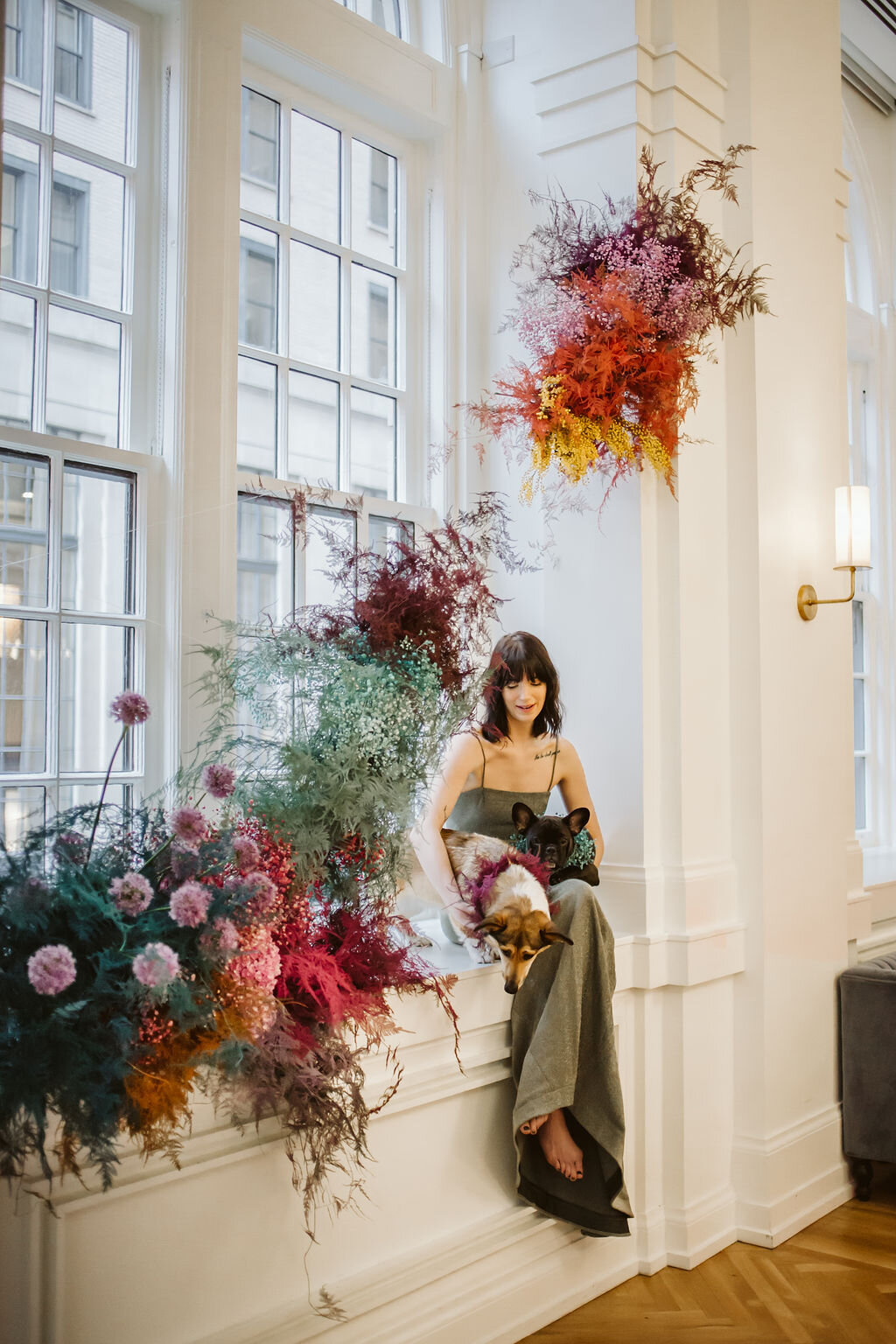 Rainbow colored floral installation with painted and dyed baby’s breath and plums ferns. Modern, minimal, colorful wedding flowers at the Noelle Hotel in downtown Nashville.
