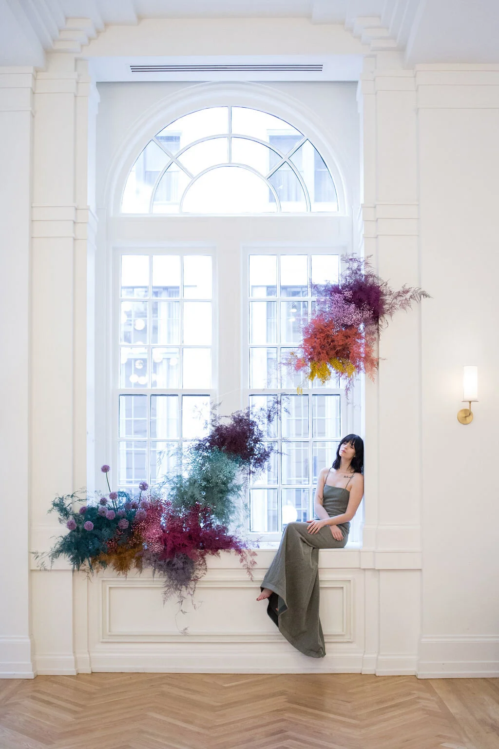 Rainbow colored floral installation with painted and dyed baby’s breath and plums ferns. Modern, minimal, colorful wedding flowers at the Noelle Hotel in downtown Nashville.