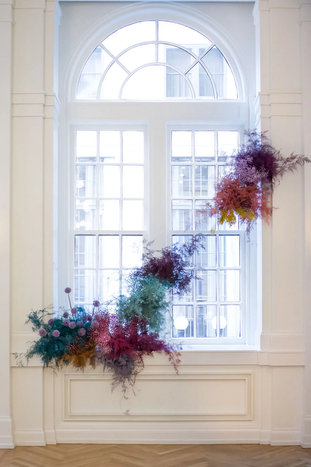 Rainbow colored floral installation with painted and dyed baby’s breath and plums ferns. Modern, minimal, colorful wedding flowers at the Noelle Hotel in downtown Nashville.