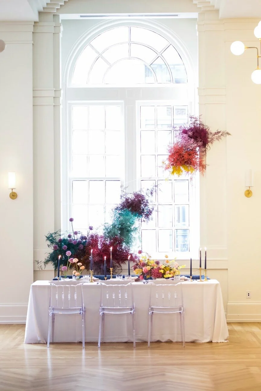Rainbow colored floral installation with painted and dyed baby’s breath and plums ferns. Modern, minimal, colorful wedding flowers at the Noelle Hotel in downtown Nashville.