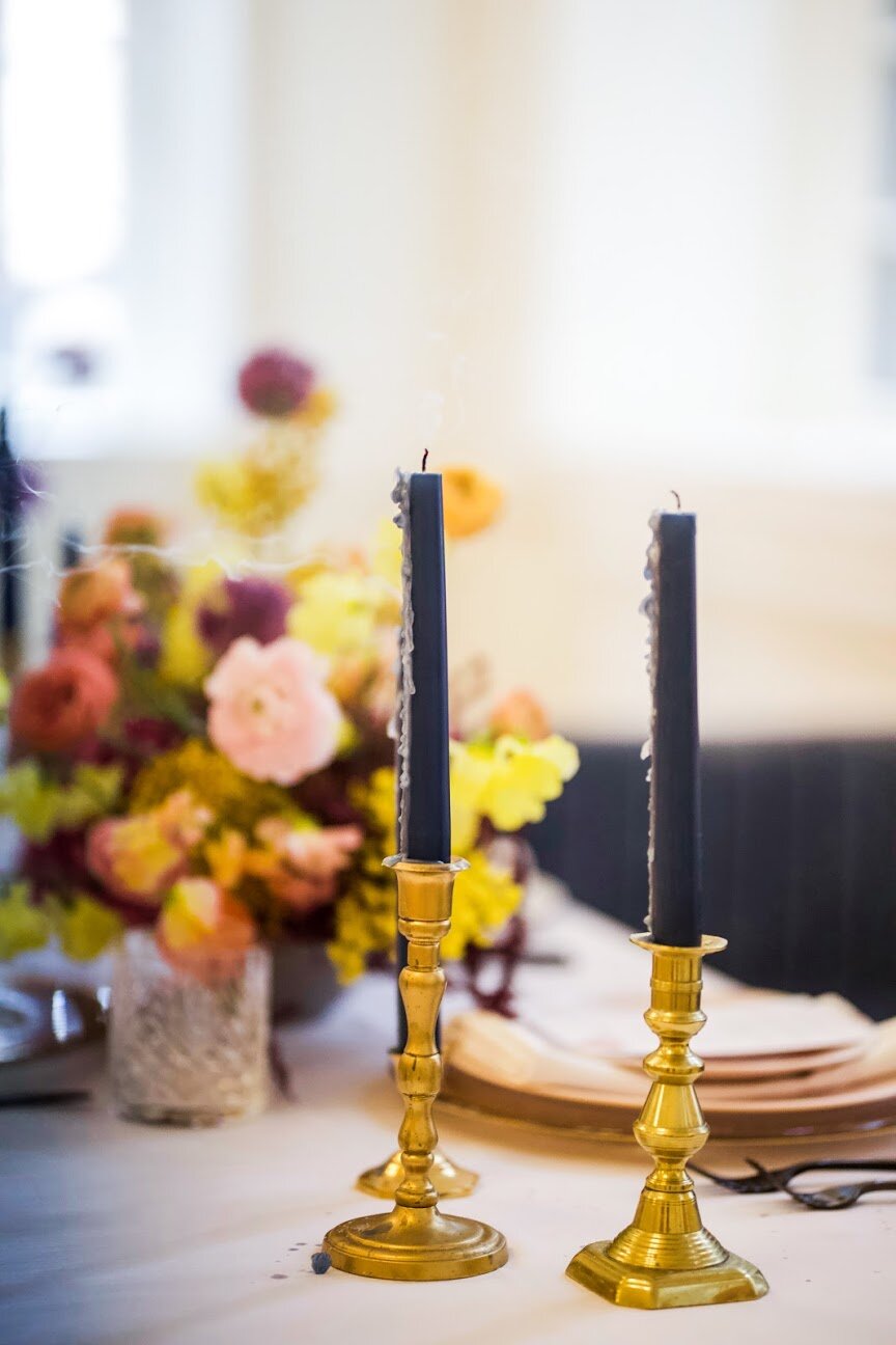 Low, colorful, modern floral centerpiece with ranunculus, sweet peas, acacia, and allium. Tennessee wedding florist.