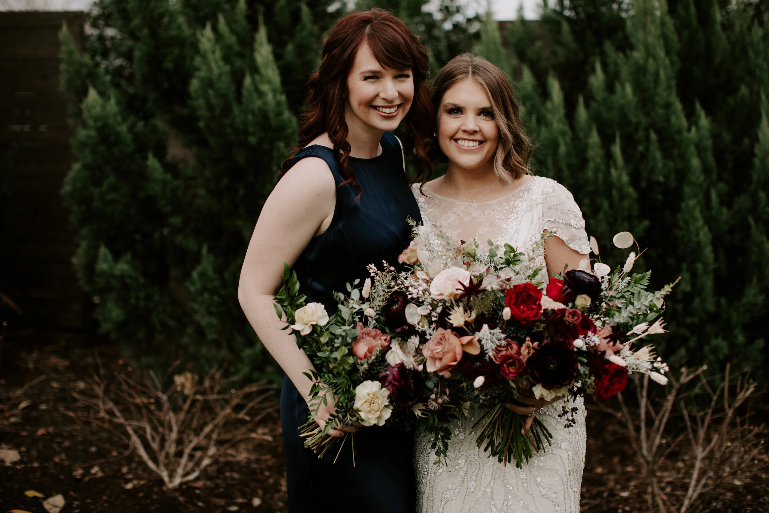 Navy silk bridesmaid dresses with jewel tone flowers with airy, natural greenery. Nashville wedding florist at the Cordelle.