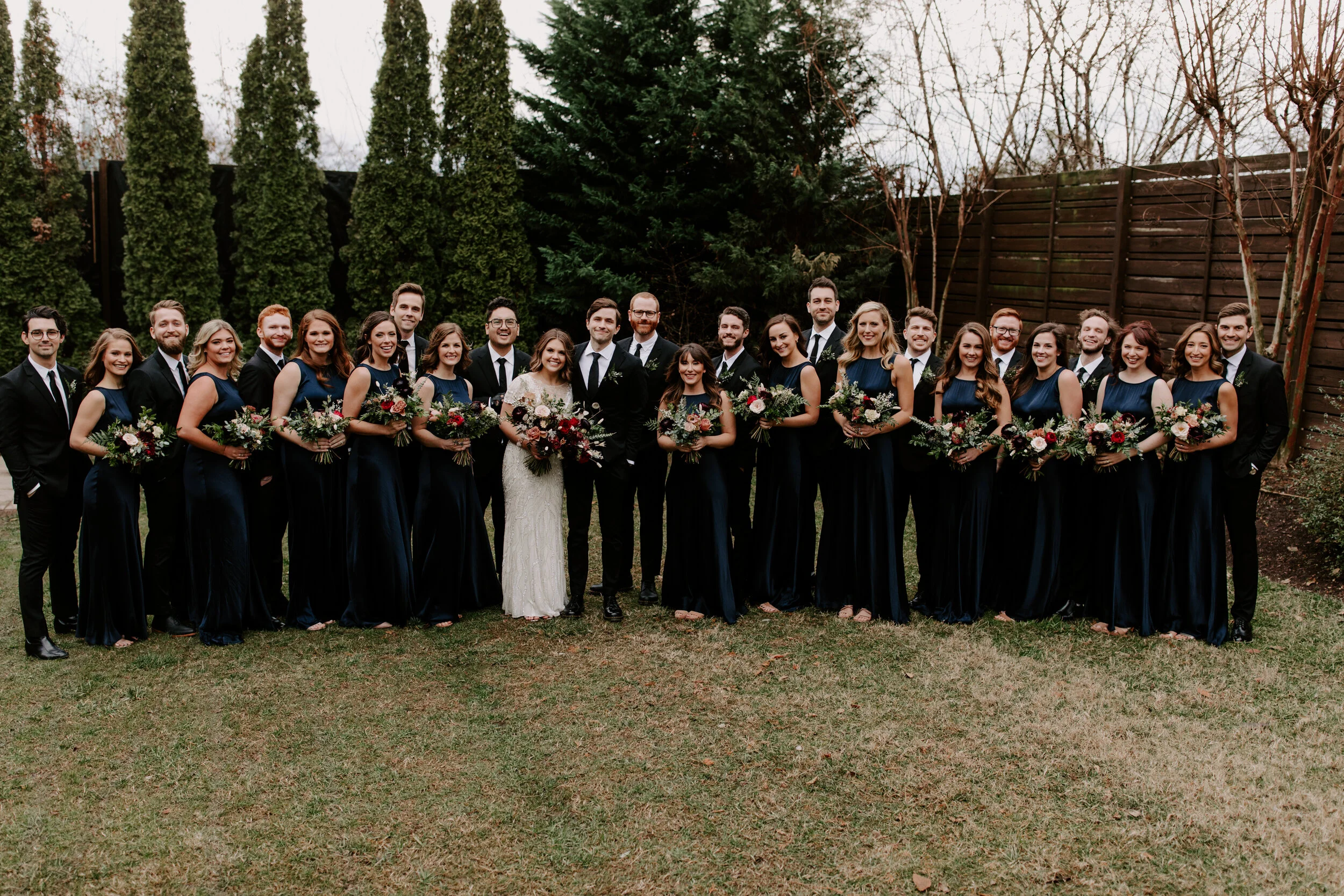 Navy silk bridesmaid dresses with jewel tone flowers with airy, natural greenery. Nashville wedding florist at the Cordelle.