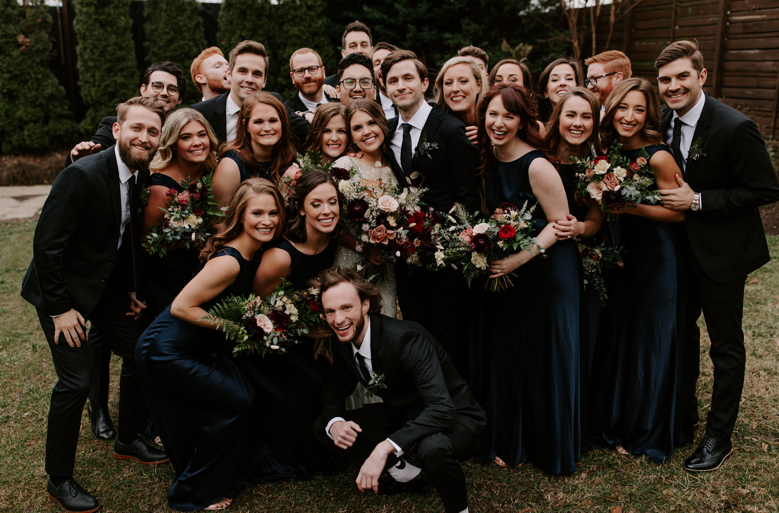 Navy silk bridesmaid dresses with jewel tone flowers with airy, natural greenery. Nashville wedding florist at the Cordelle.