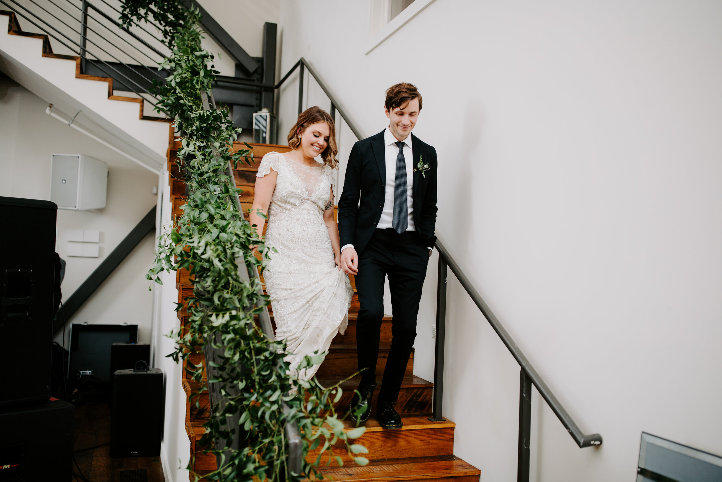 Lush greenery trailing up the staircase. Nashville wedding florist at the Cordelle.