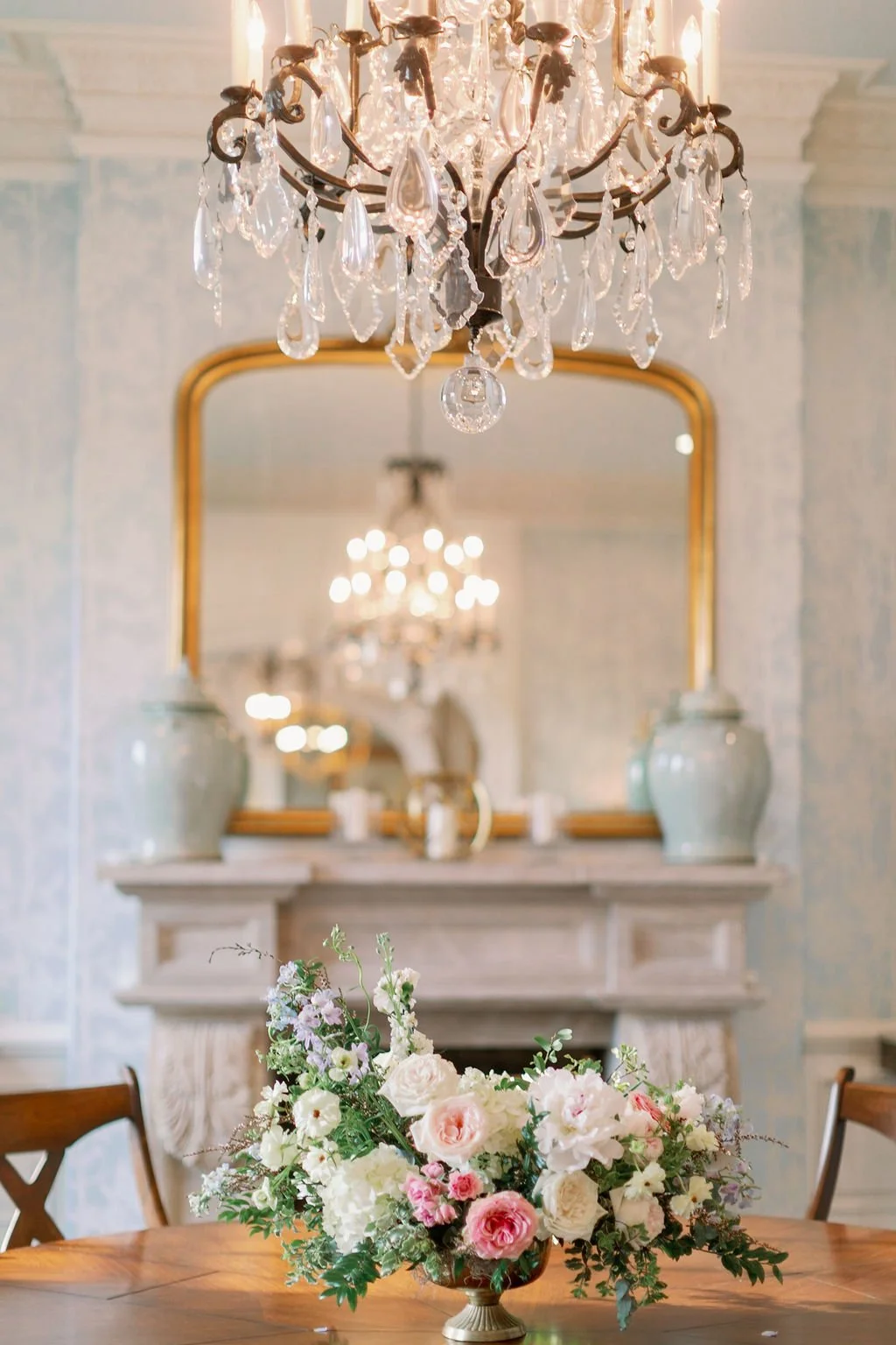 This private estate wedding creates a garden-inspired setting in hues of ivory, pink, blush, and French blue composed of petal heavy roses, peonies, hydrangeas, ranunculus, delphinium, spray roses, and natural greenery. Designed by Rosemary & Finch i