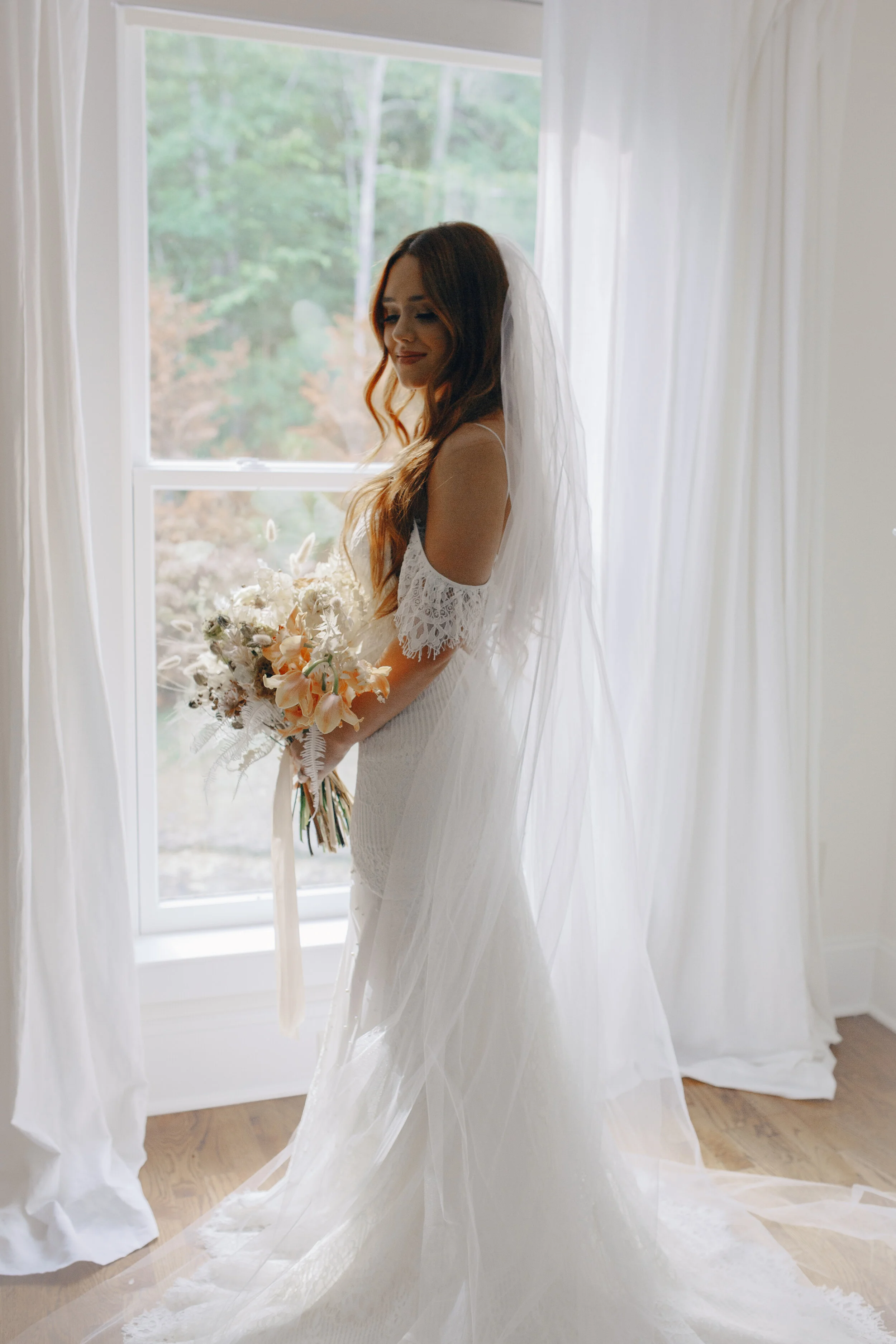 Lush, bohemian bridal bouquet with white garden roses, copper orchids, dried white ferns, earthy textures, and toffee lisianthus. Nashville wedding and elopement floral designer.