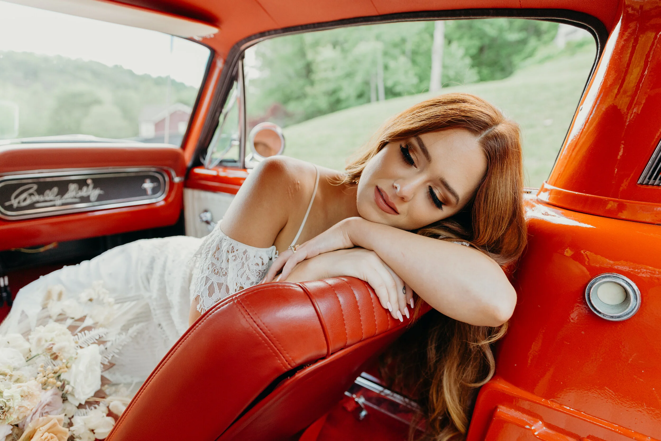 Lush, bohemian bridal bouquet with white garden roses, copper orchids, dried white ferns, earthy textures, and toffee lisianthus. Nashville wedding and elopement floral designer.