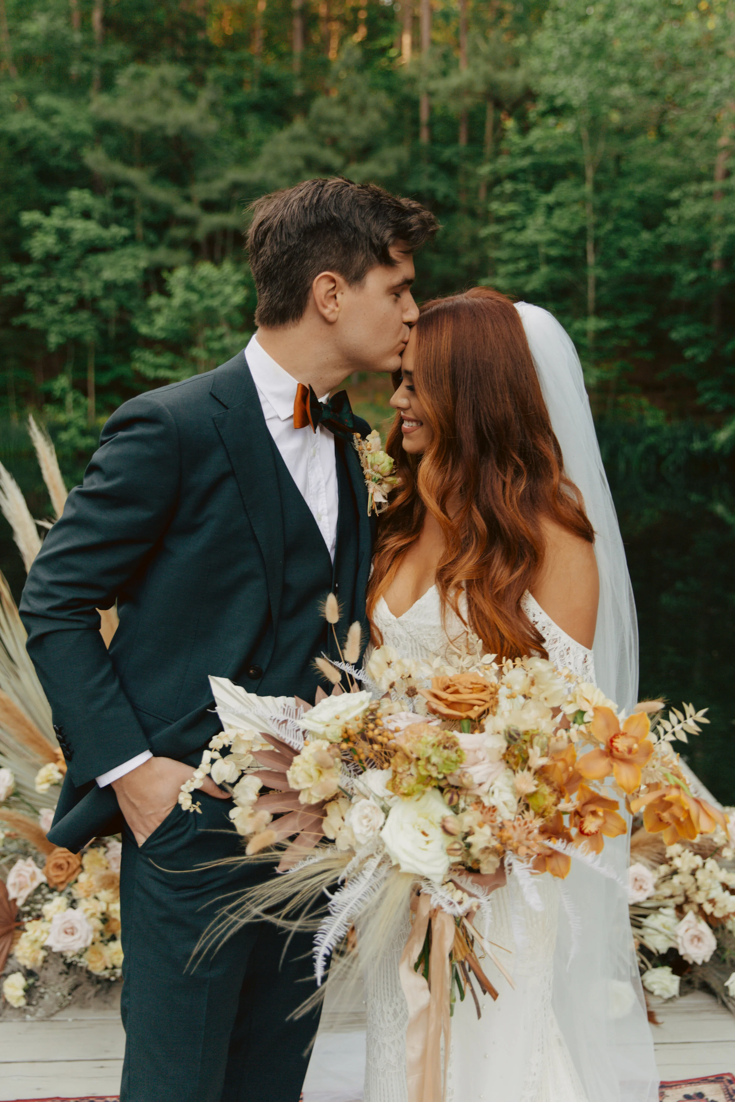 Lush, bohemian bridal bouquet with white garden roses, copper orchids, dried white ferns, earthy textures, and toffee lisianthus. Nashville wedding and elopement floral designer.