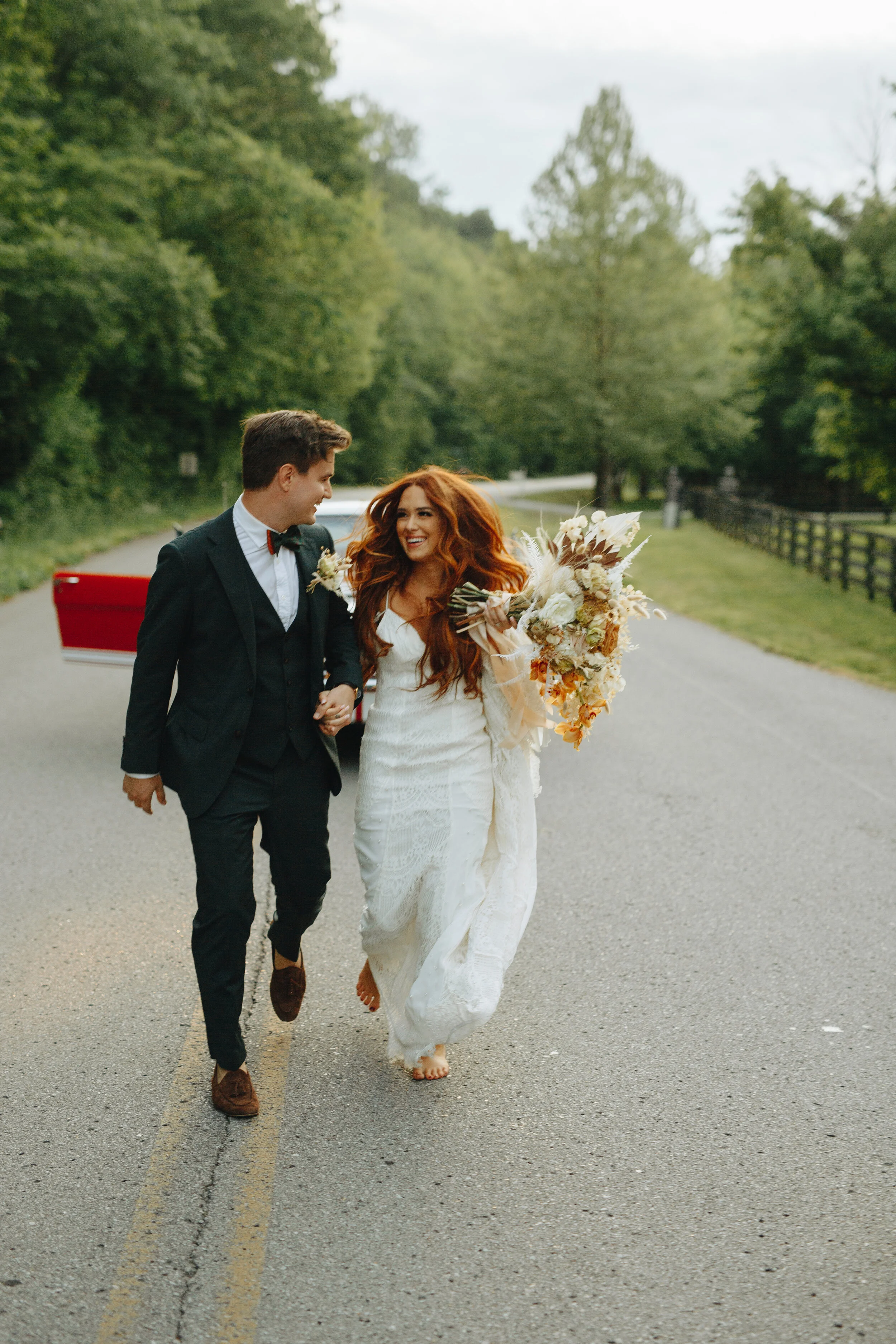 Lush, bohemian bridal bouquet with white garden roses, copper orchids, dried white ferns, earthy textures, and toffee lisianthus. Nashville wedding and elopement floral designer.