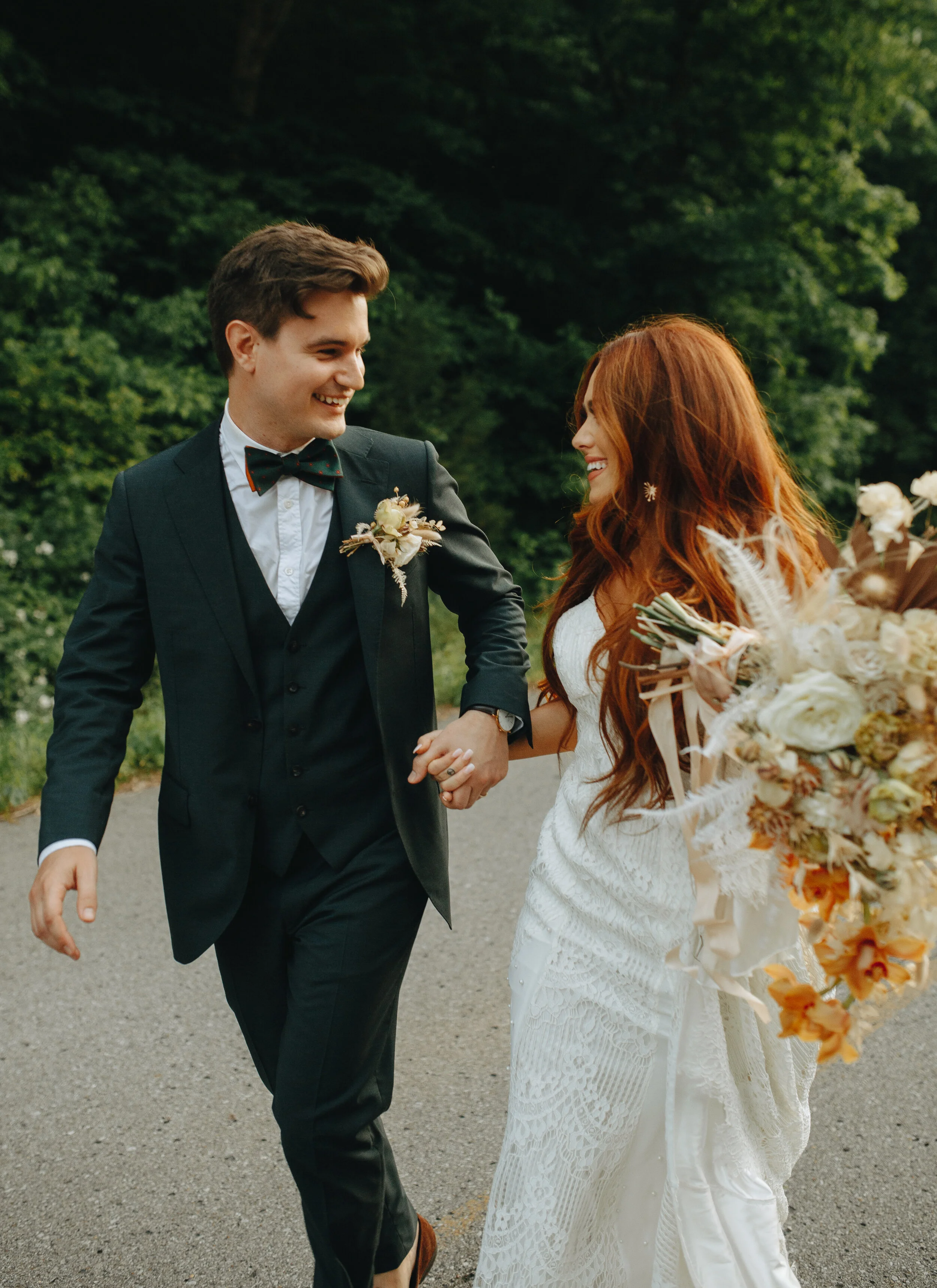 Lush, bohemian bridal bouquet with white garden roses, copper orchids, dried white ferns, earthy textures, and toffee lisianthus. Nashville wedding and elopement floral designer.
